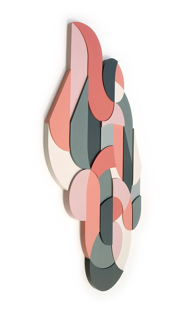 side view of a painted wood sculpture featuring various spirals and swirls in gray, pink, and white by Scott Albrecht