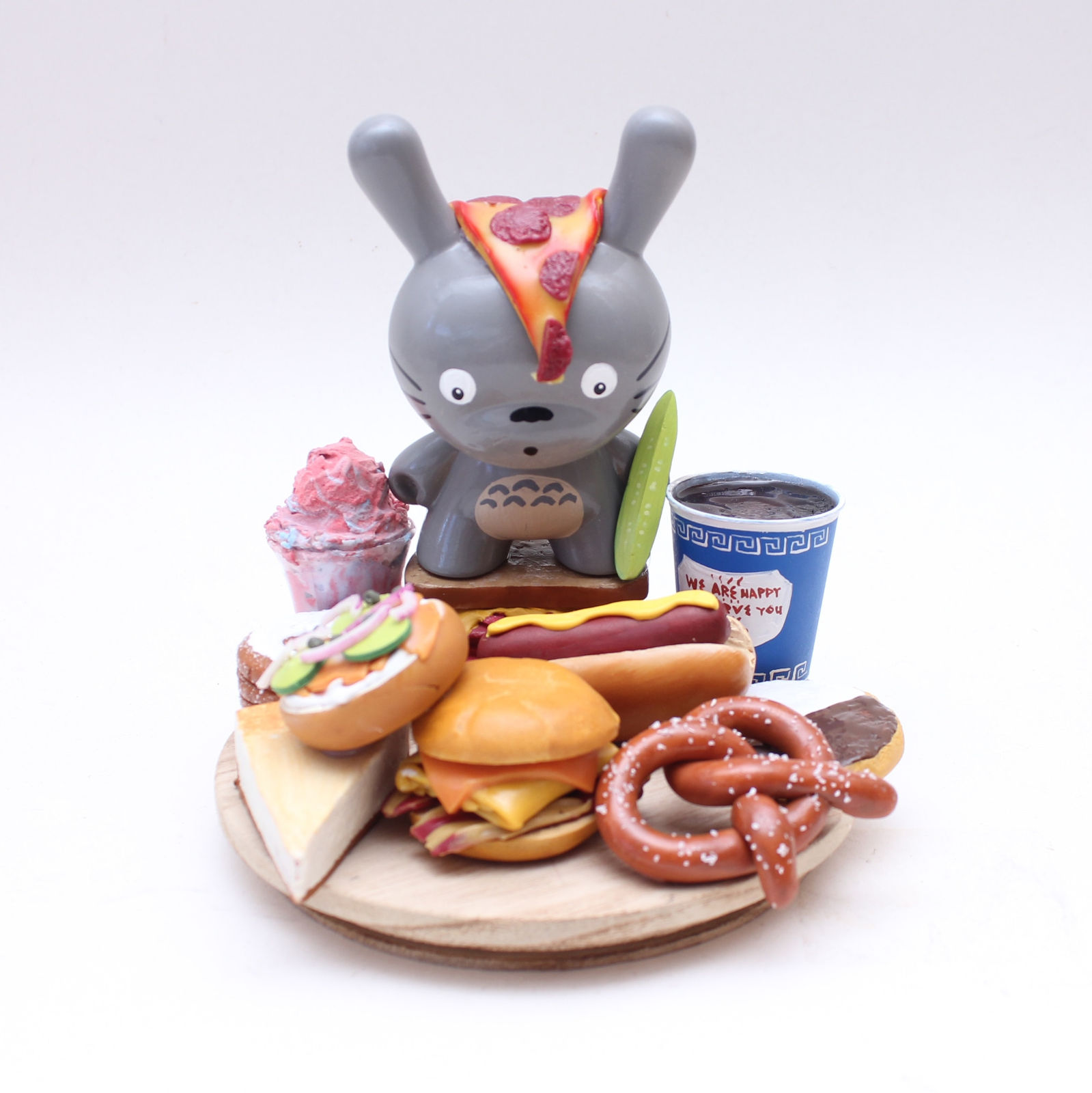 Vinyl Totoro figure with a platter of classic NYC food