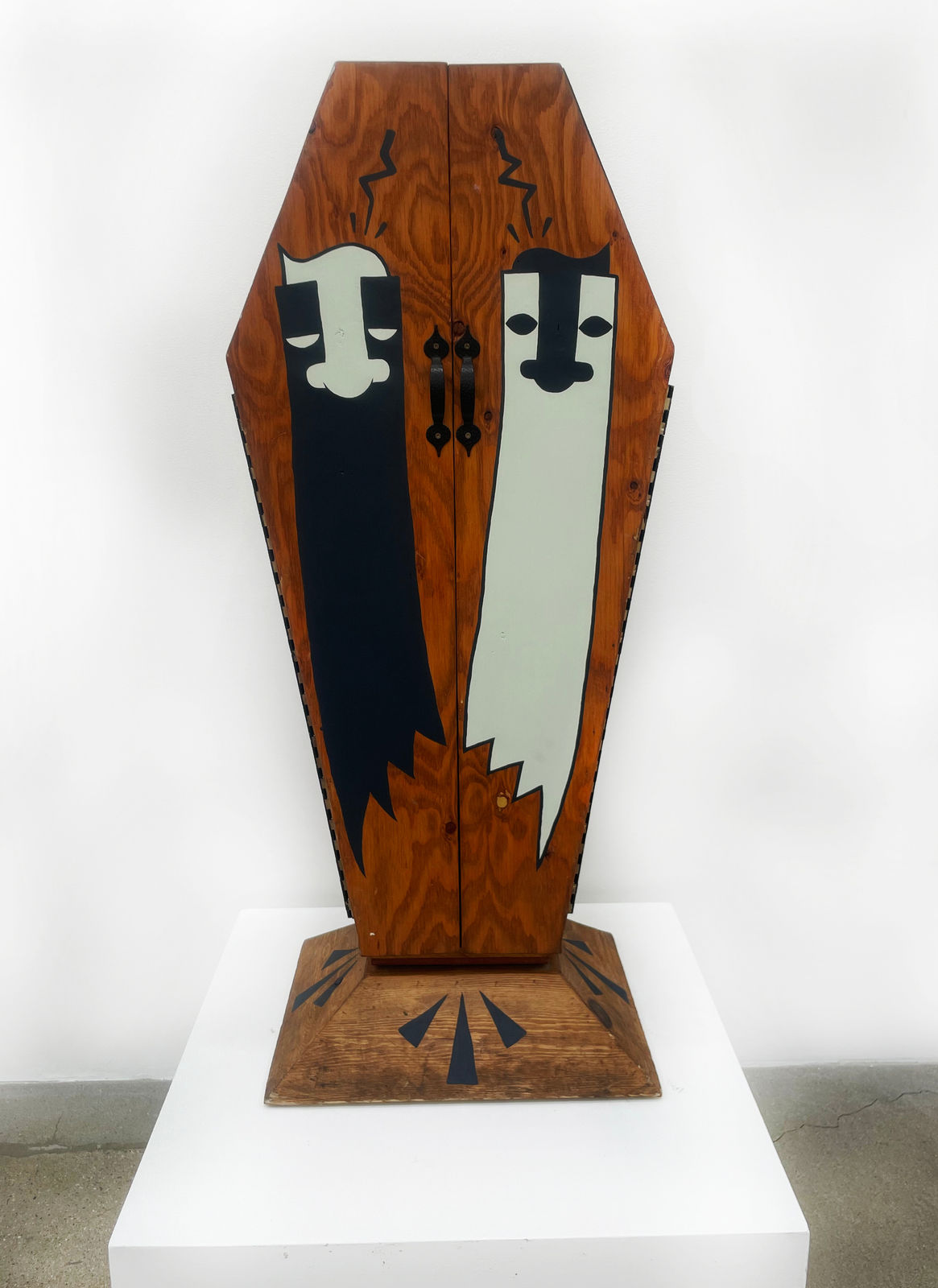 Wooden coffin with two ghost painted on the front doors and GATS written on the side