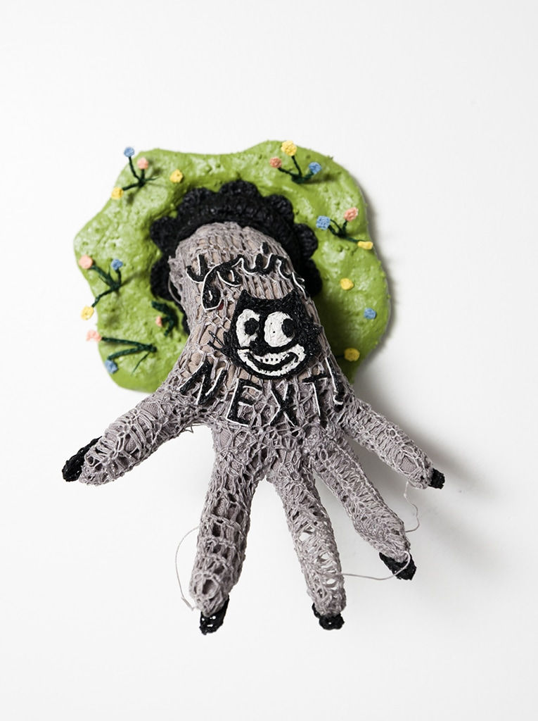 crocheted thread sculpture of a hand