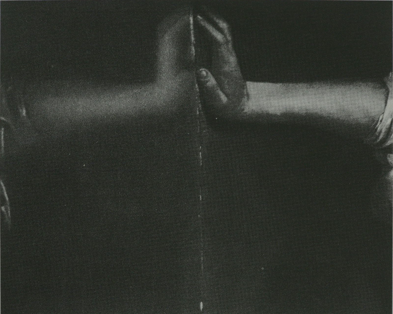 Black and white photograph of two hands touching palm to palm