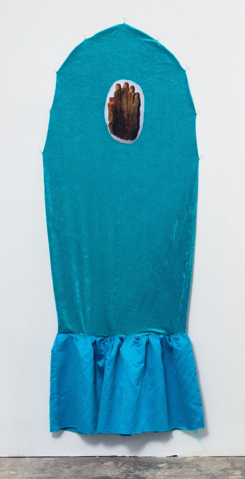 Abstract portrayal of a blue fabric ghost with a collaged hand