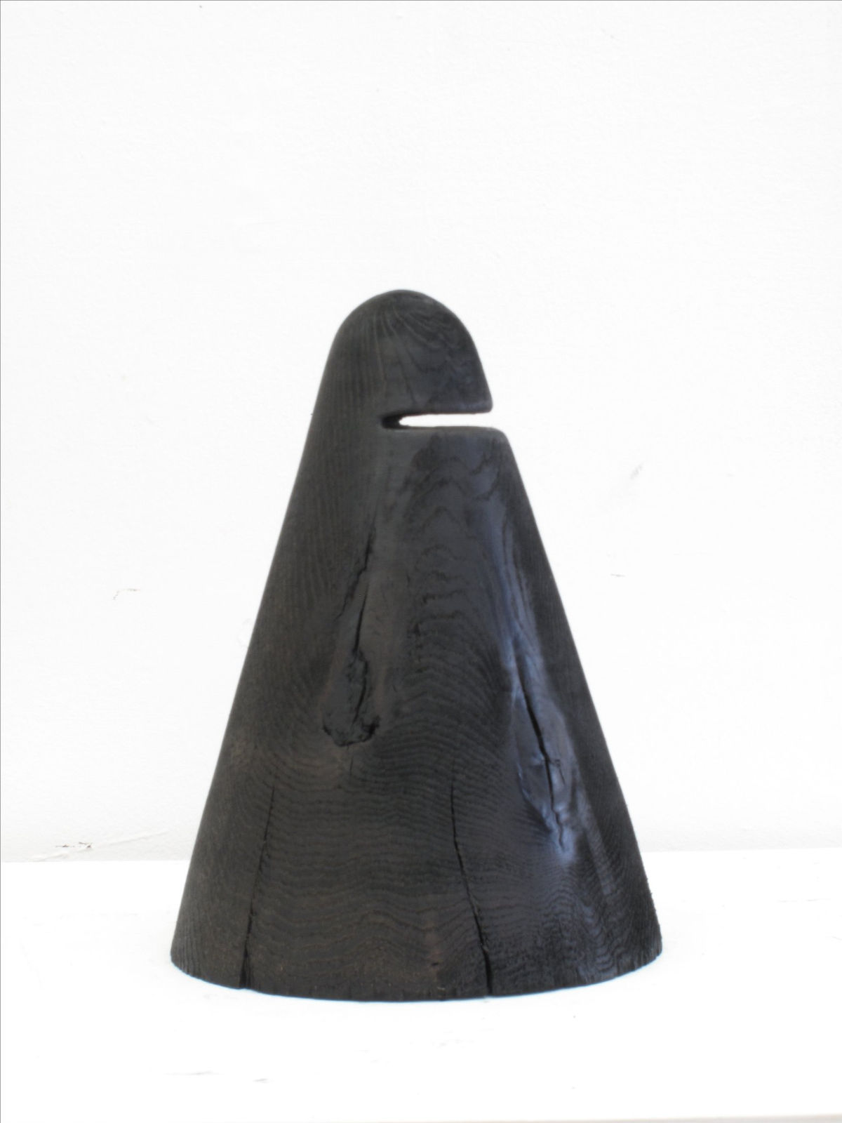 Carved wood sculpture with cartoon anatomical elements