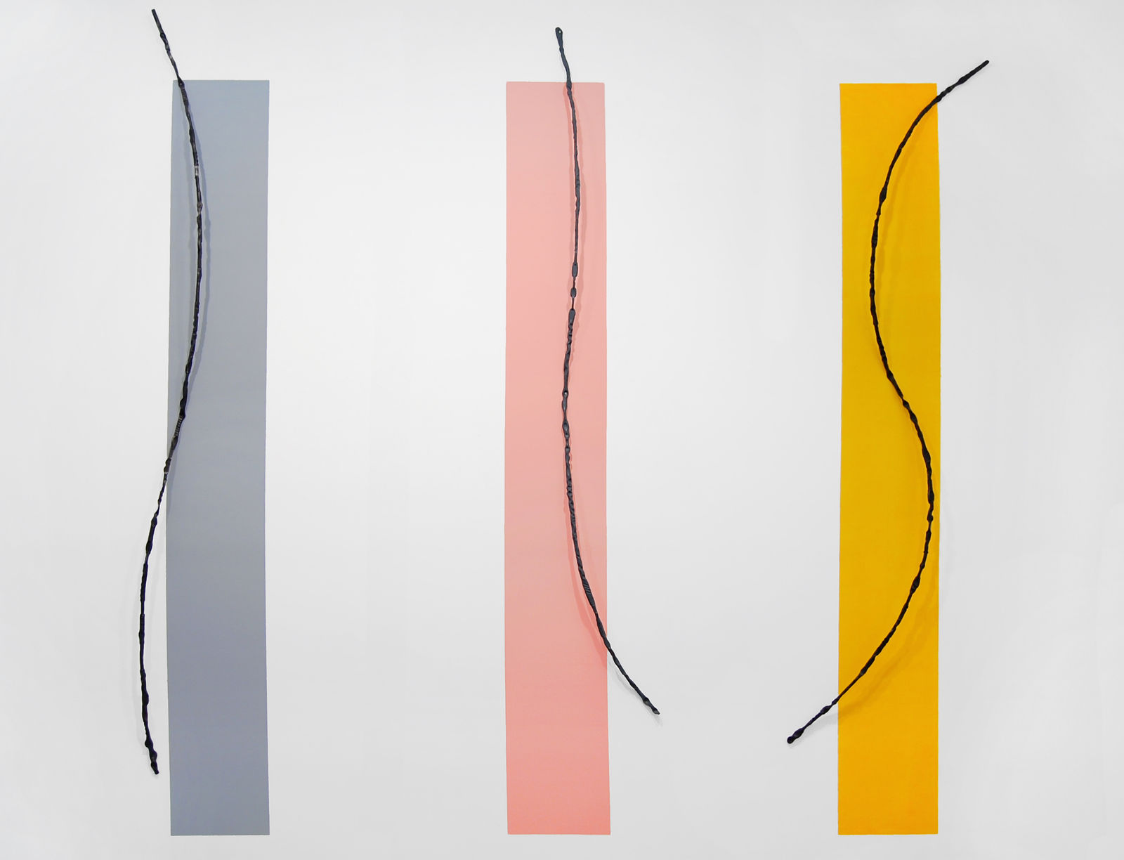 Three thin rectangles, one in gray, one in peach, and one in yellow with gentle black swoop in front of each