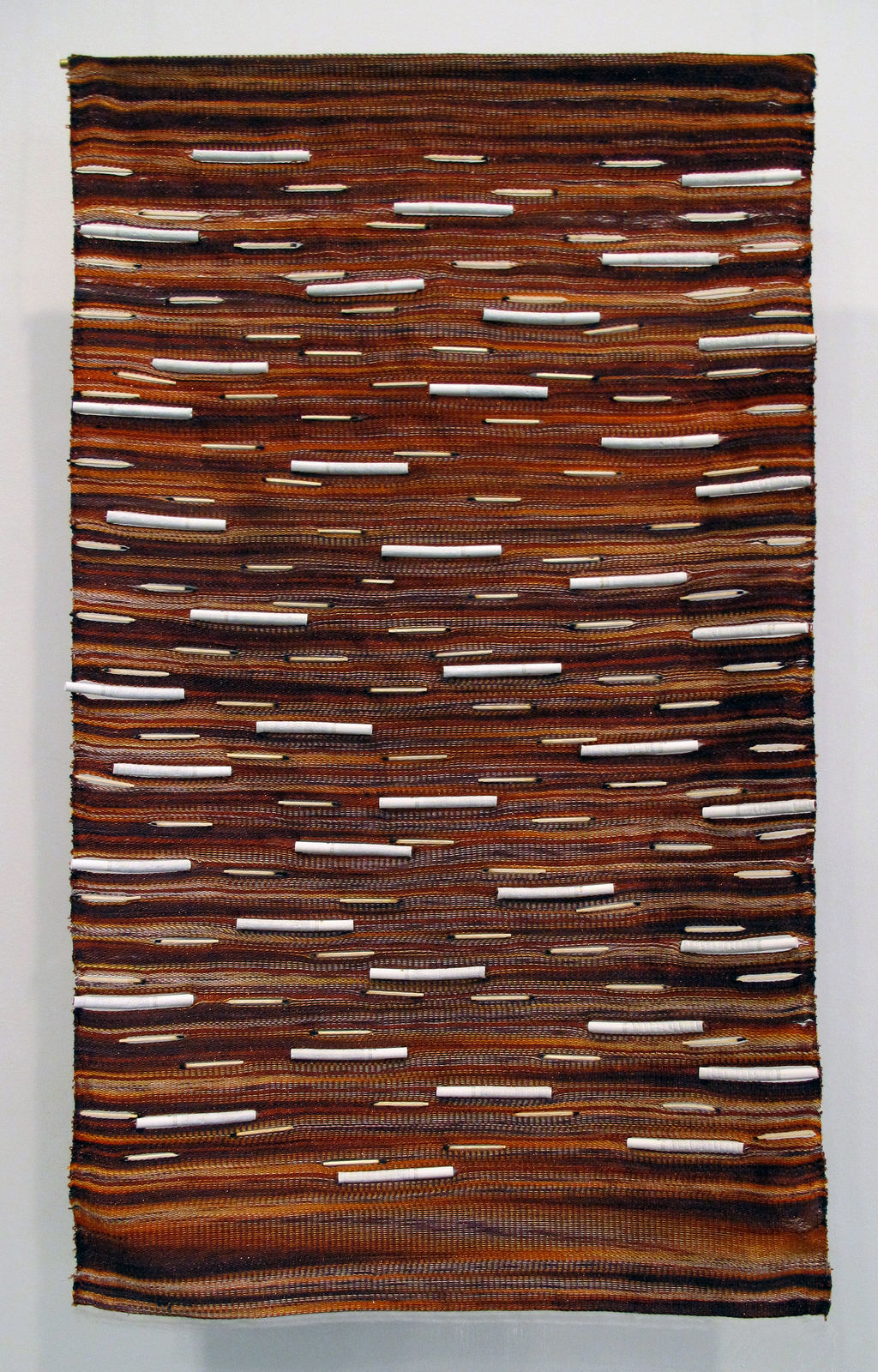 Woven wall hanging with cigarettes