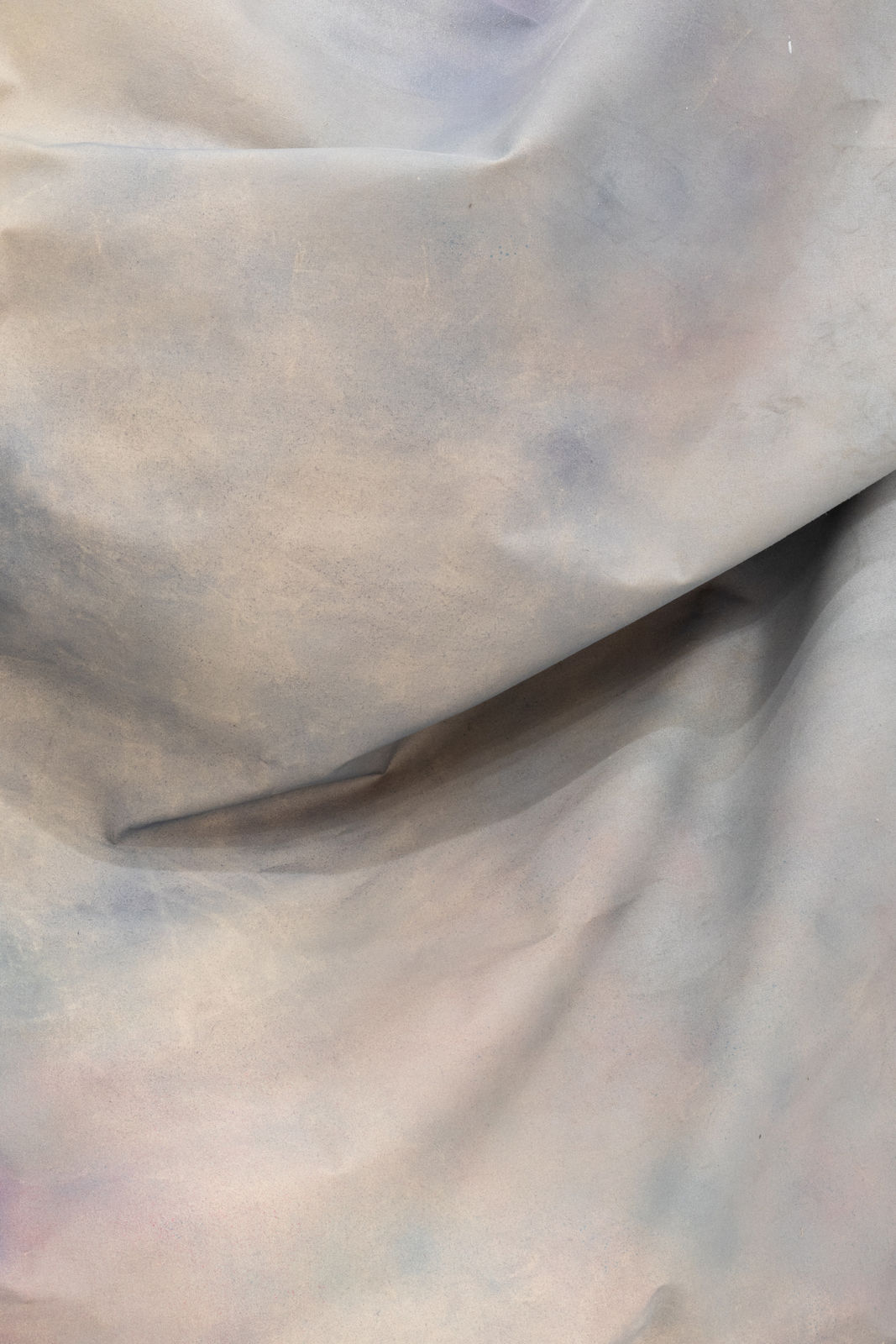 detail shot of draped fabric sculpture on wall