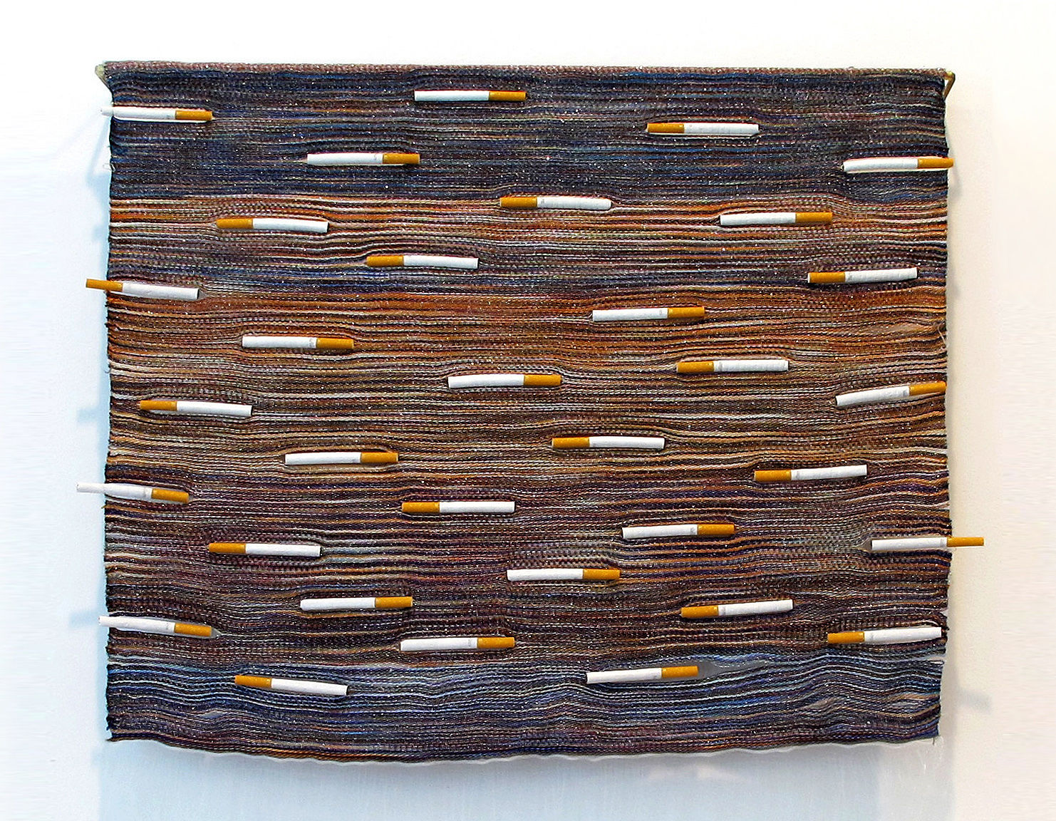 Woven wall hanging with cigarettes