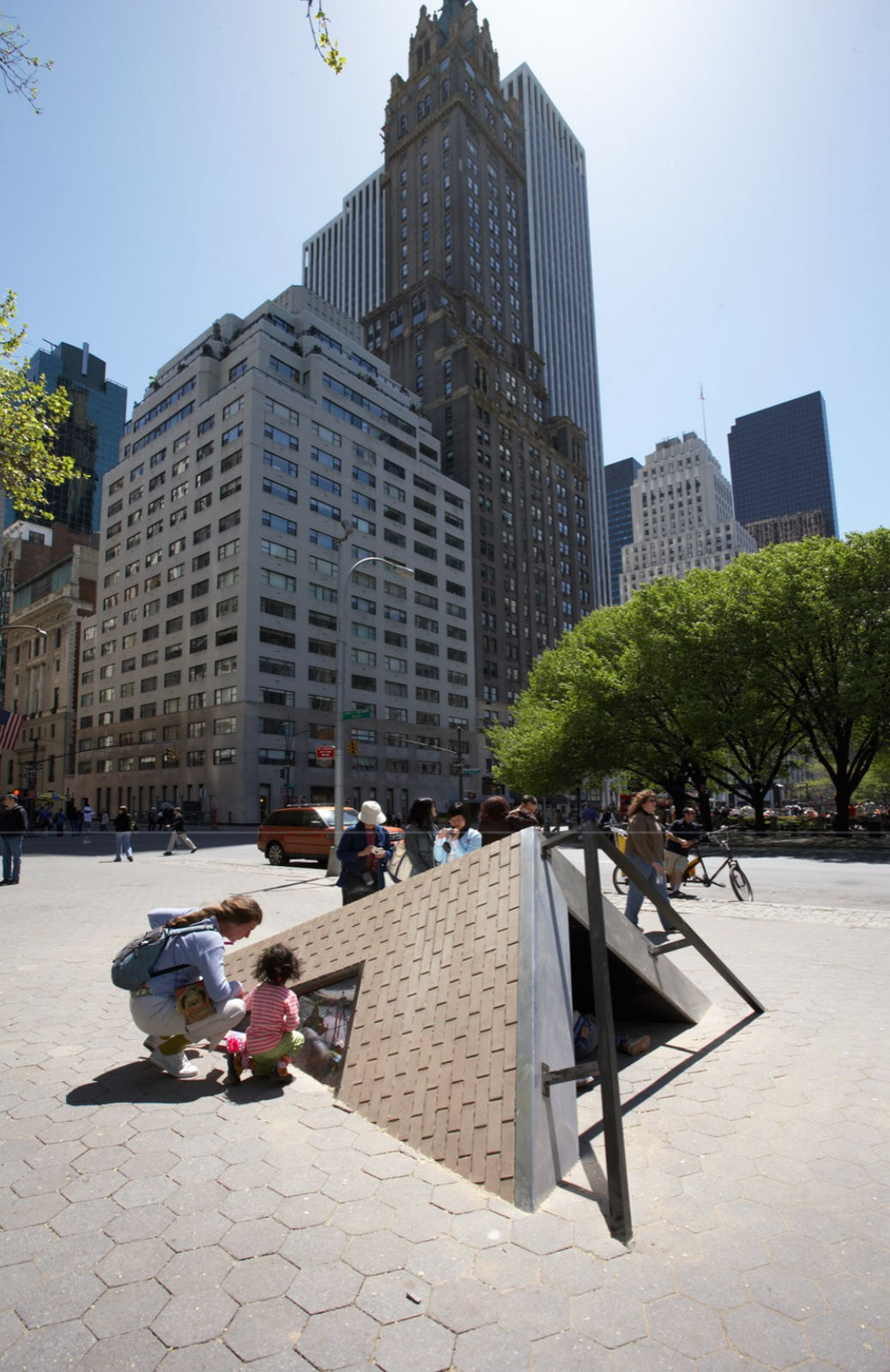 corner of building coming out of sidewalk