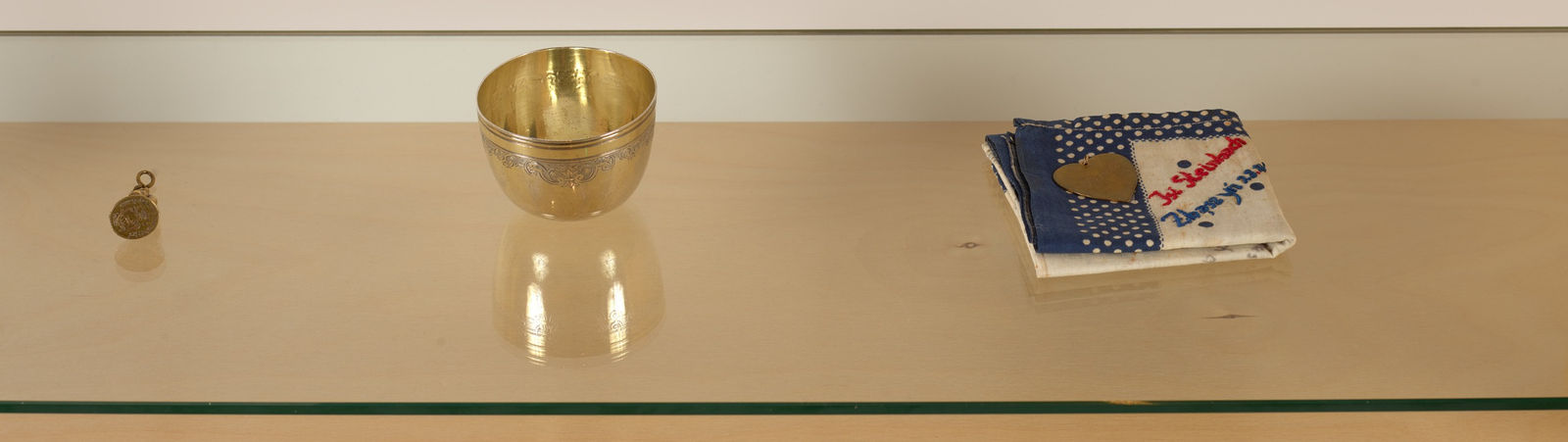 Image of Untitled (5 bottles, noisemaker, angel, stamp, cup, pendant, handkerchief, dreidel).