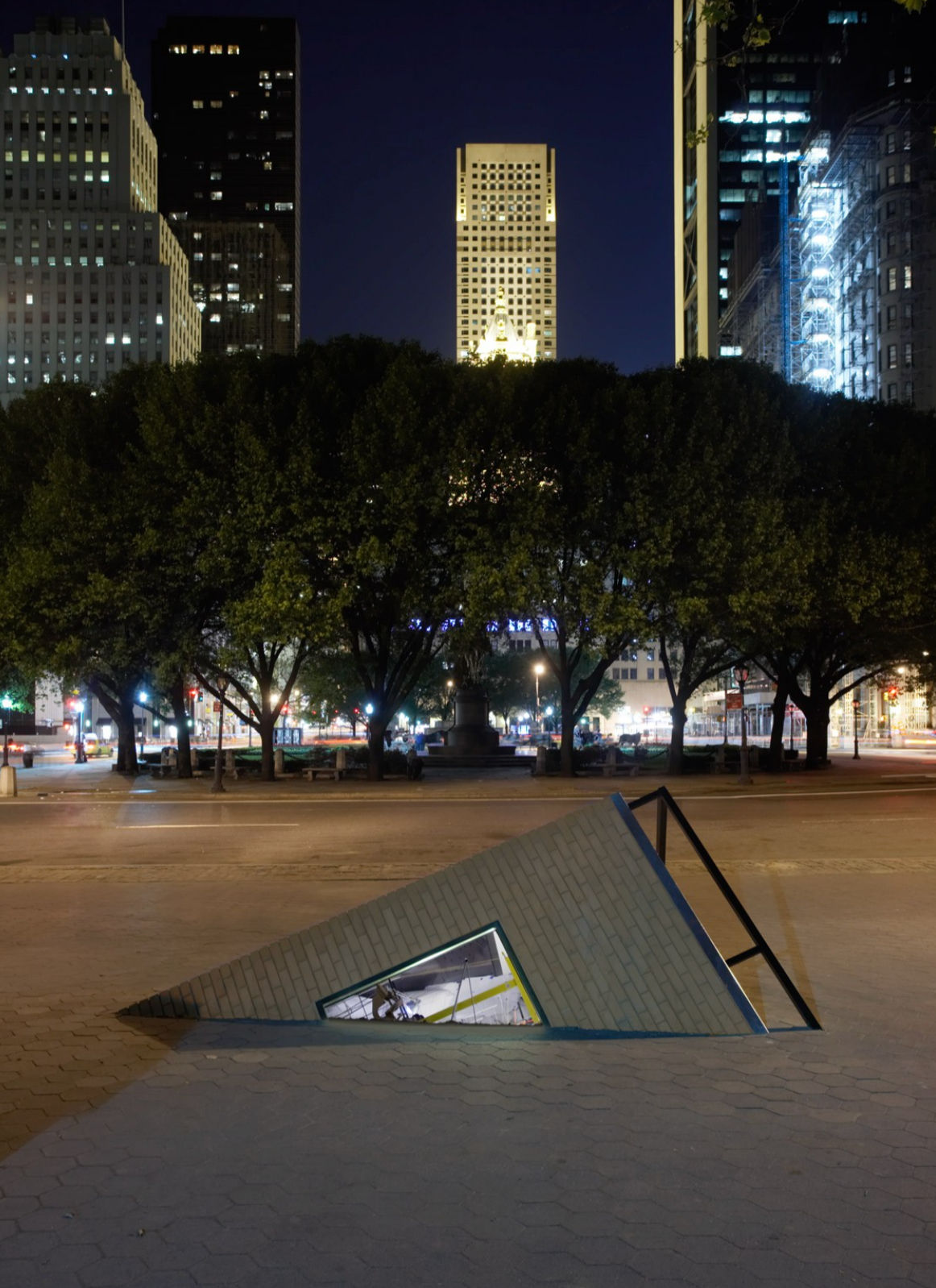 corner of building coming out of sidewalk