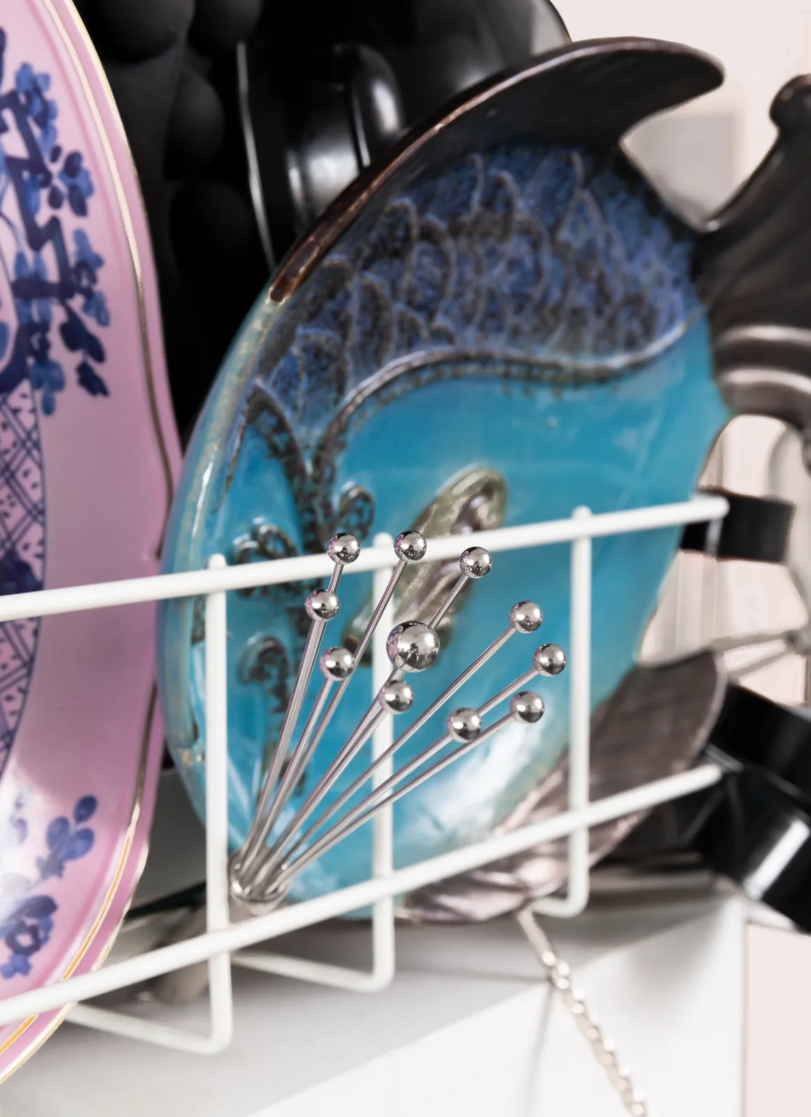 Sculpture with various china, ceramic, kitchen utensils and modified dishwasher on pedestal