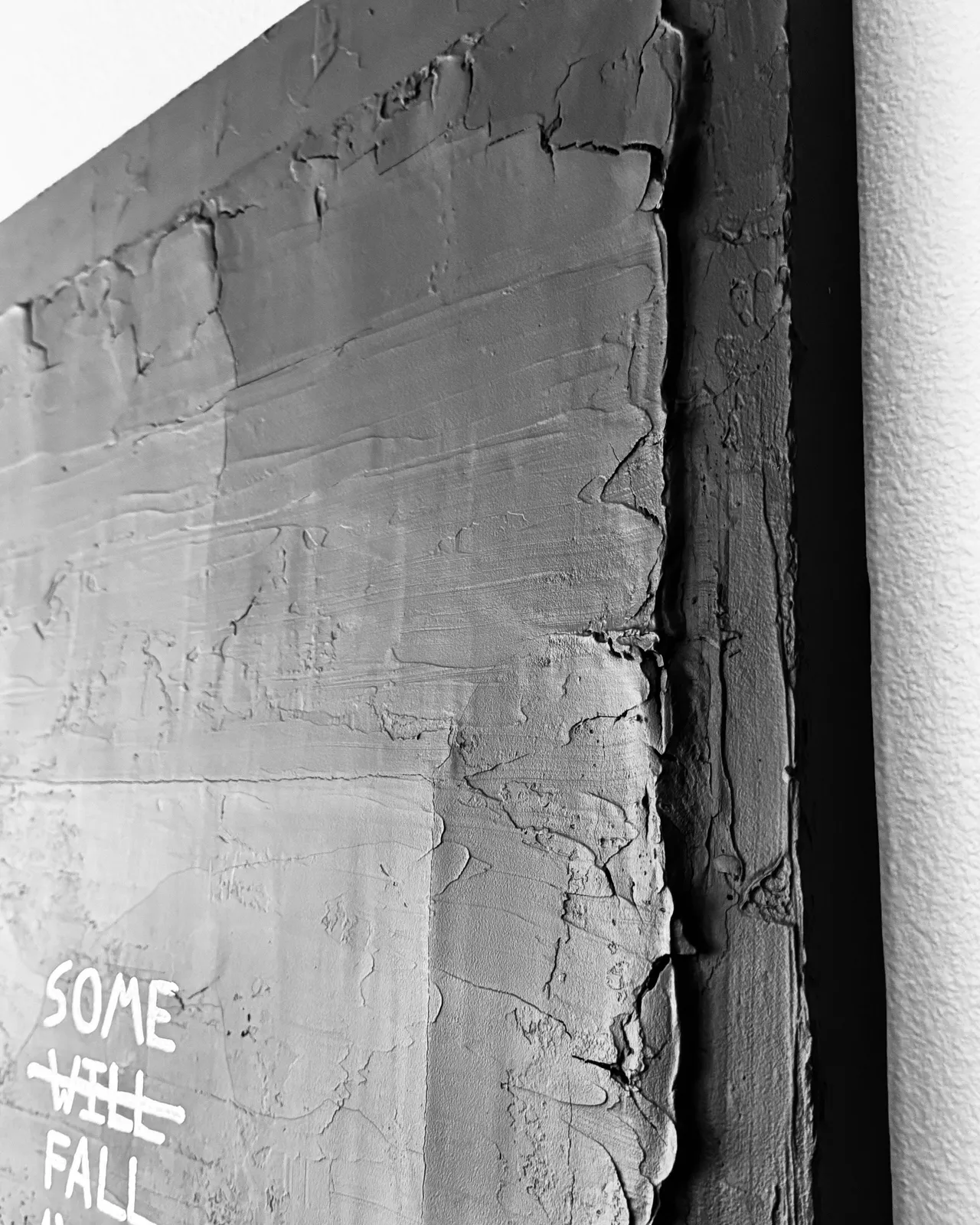 A side-angle macro photograph highlighting the thick, sculptural ridges of the joint compound and the way the light catches the layered chrome and black finish.