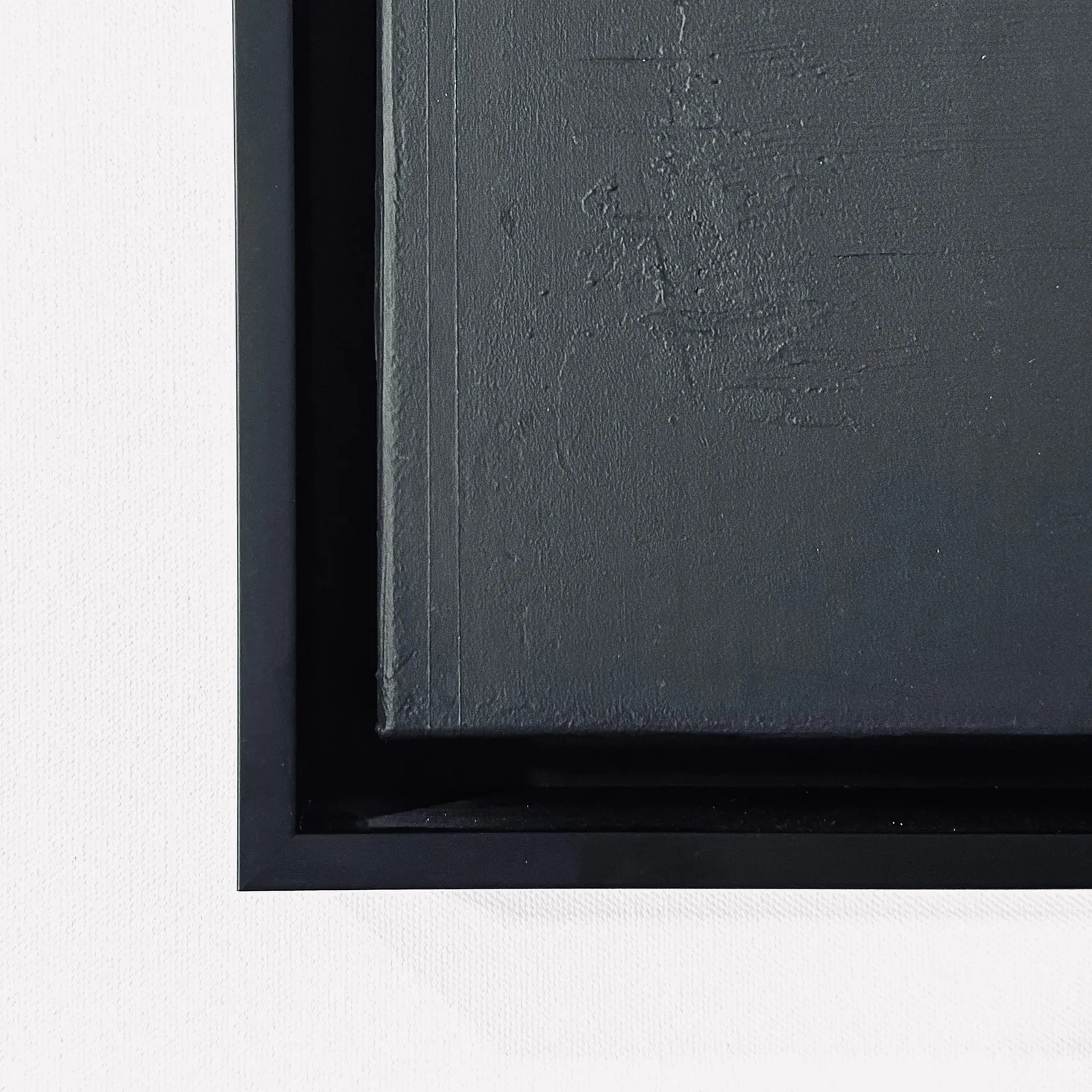 A front-facing view of the artwork in its custom black floater frame, emphasizing the shadow gap between the canvas and the wood.