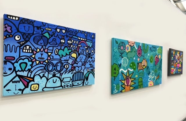 Two street style cartoon art painting hung on wall