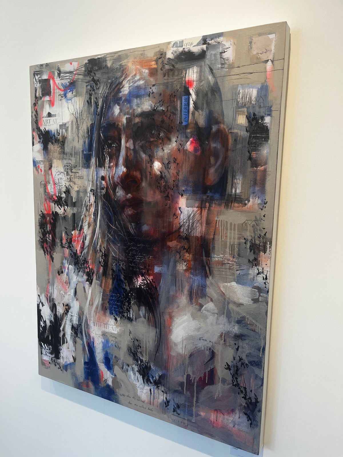 Original Painting with spray paint by British female artist Toni Codgell titled Wild Birds, depicting a close-up of a women’s face with layers of beige, blue and pick accents with painted words and collaged images in a street art style. Turner Art Perspective, Essex Gallery.