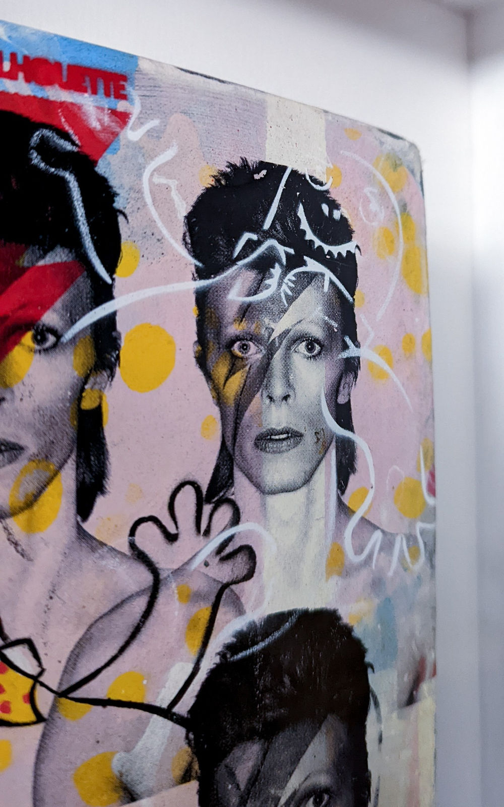 Lhouette pop art culture and collage artist creating works our of book covers and acrylic paints featuring david bowie and mr blobby pink yellow red and blue