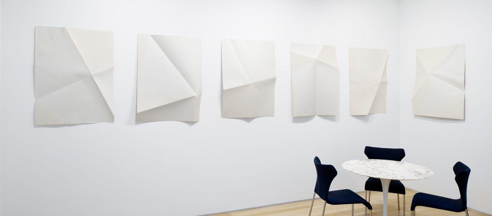 Series of white folded paper pieces