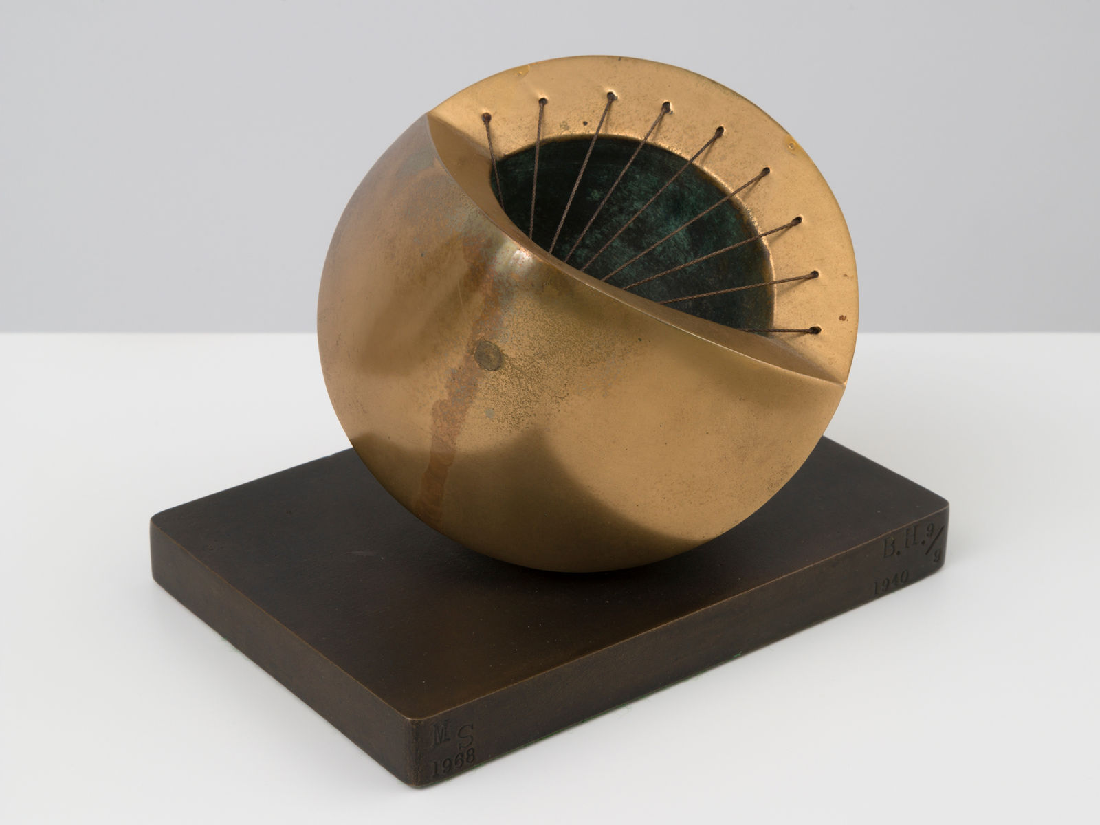 small bronze sculpture with a green inside