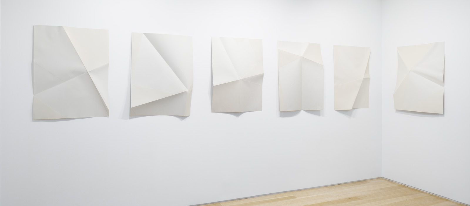 Series of white folded paper pieces