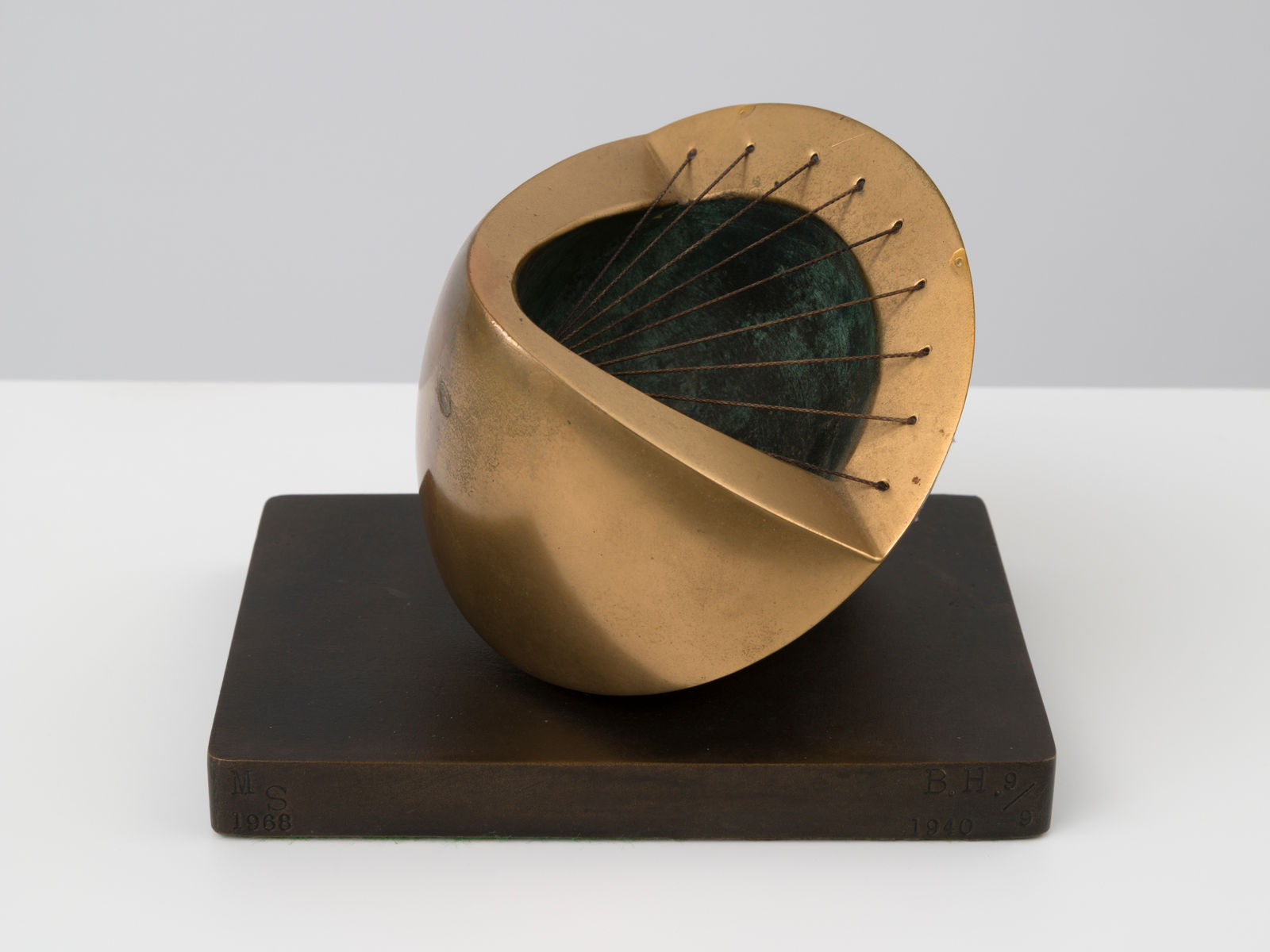 small bronze sculpture with a green inside