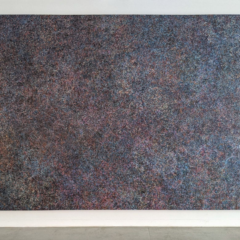 Detail of large acrylic and mixed media on canvas in an abstract expressionist mode of thousands of multicolored small rings creating a sense of cosmic depth