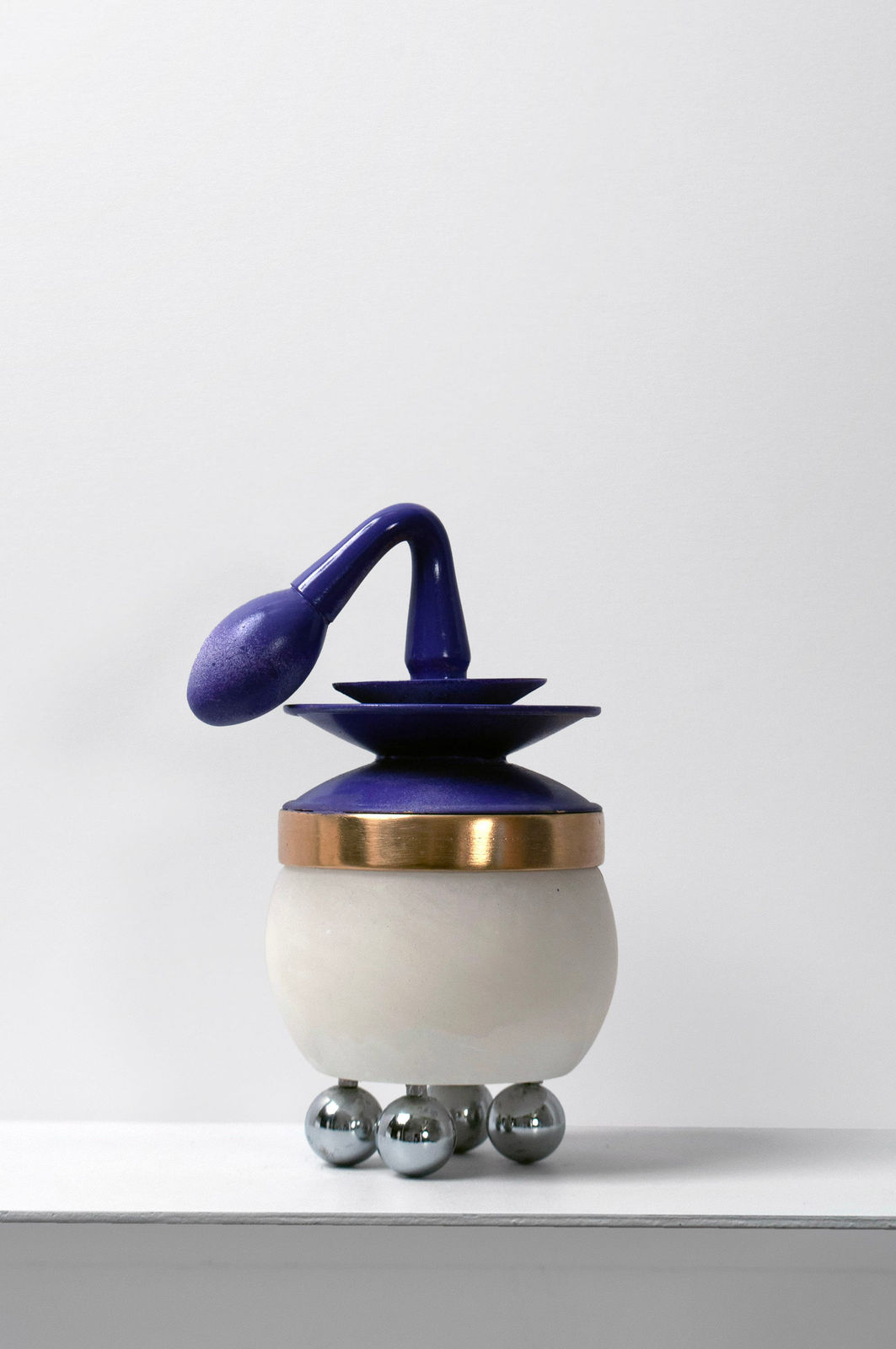 Contemporary minimalist sculpture made of stone and metal that resembles an ambiguous artifact