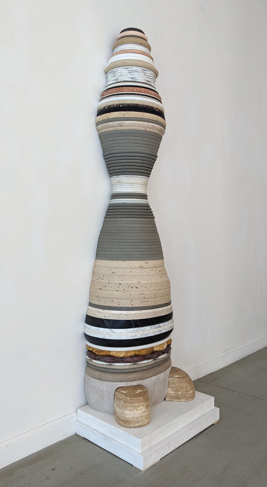 Detail of Mulitlayered and colored sculpture with layers moving in and then back out in a elongated, hourglass shape