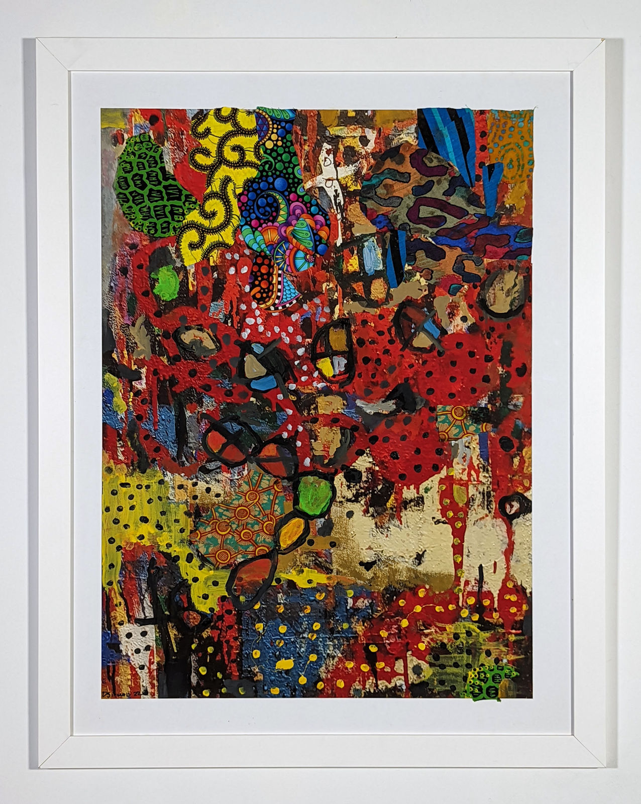 White framed colorful artwork comprised of oil and patterned fabric on print in a 