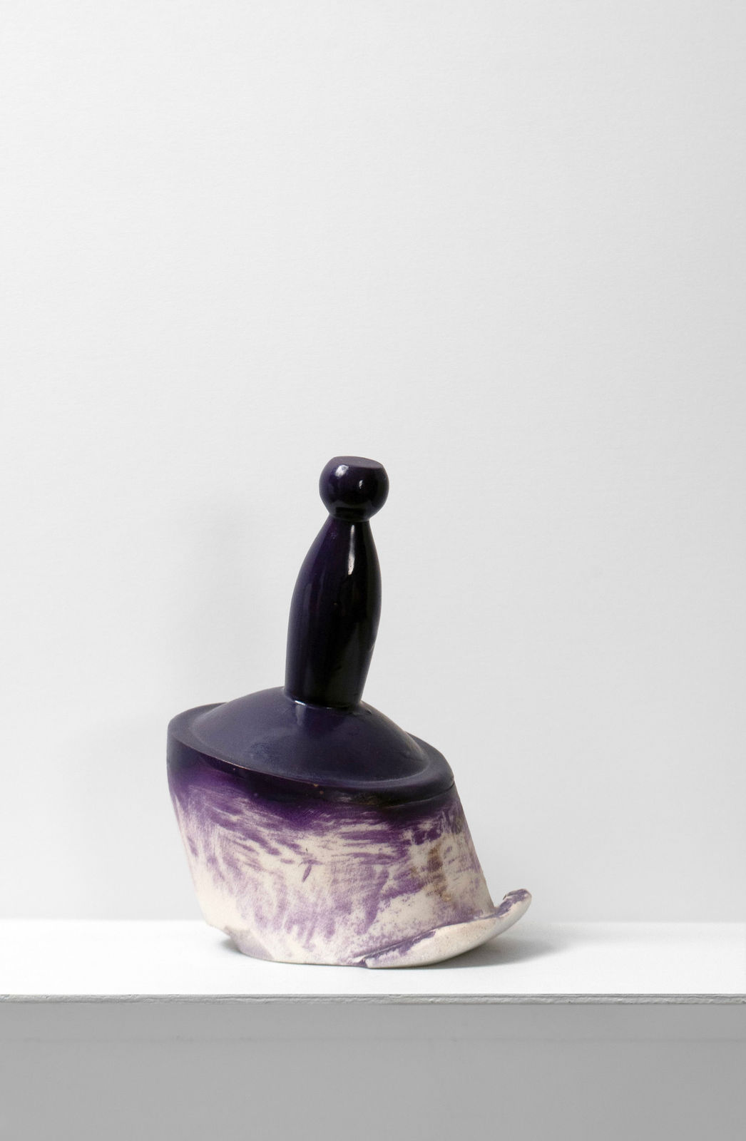 Contemporary minimalist sculpture made of stone and metal that resembles an ambiguous artifact