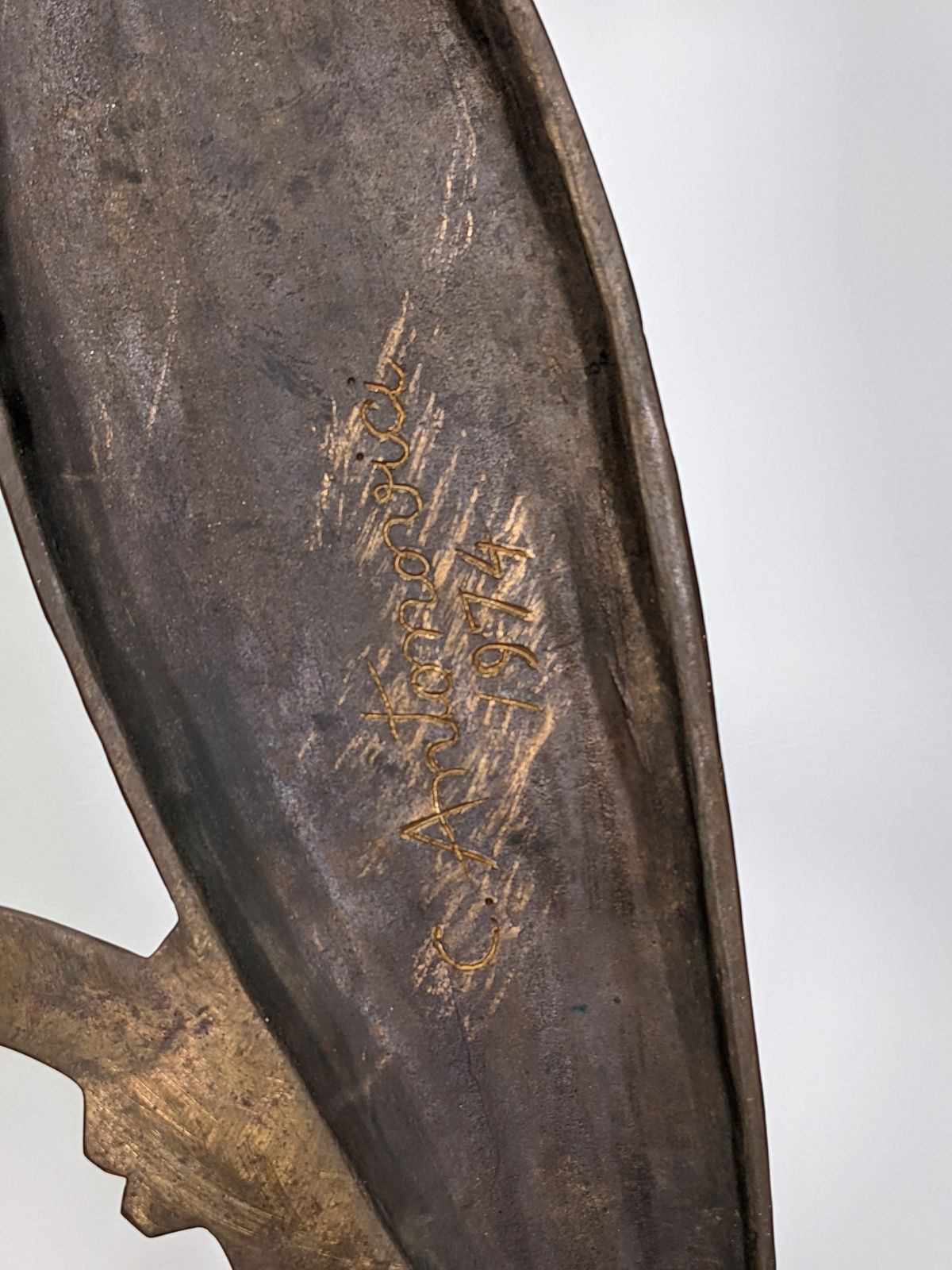 Detail of Modernist bronze sculpture of a stylized owl with large eyes perched on a circular base
