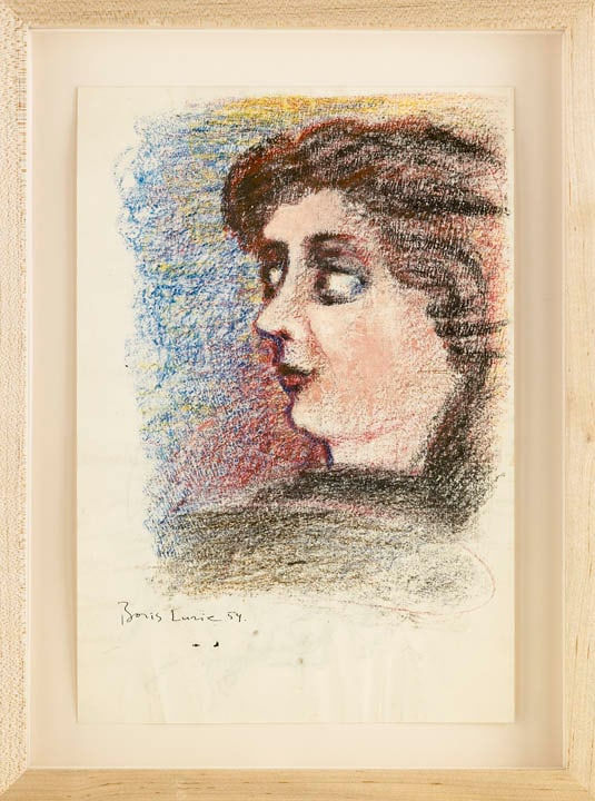 Framed pastel drawing of a profile of a young woman with long hair, looking outside the paper