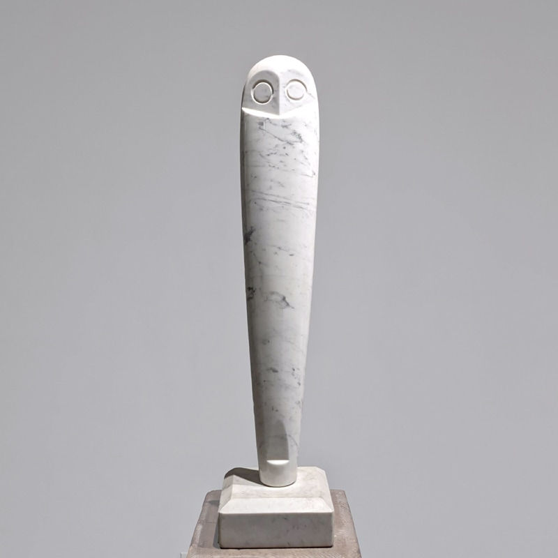 Modernist white marble sculpture of vertical owl with stylized eyes and head, on white marble base