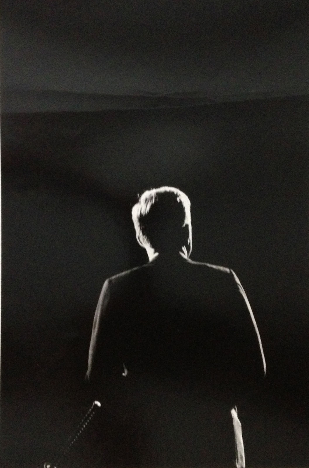 Black and white photograph of John F Kennedy's silhouette from behind