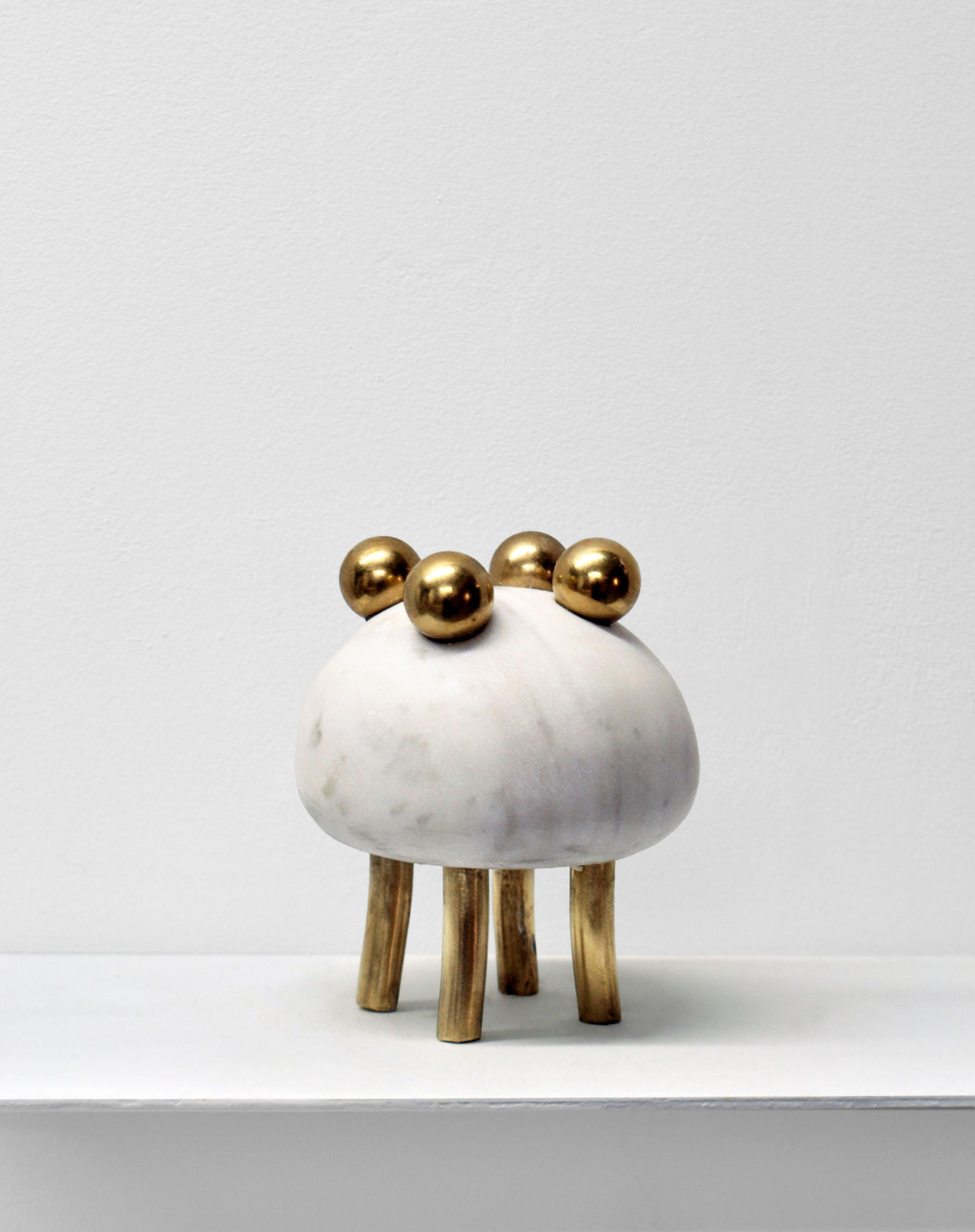 Contemporary minimalist sculpture made of stone and metal that resembles an ambiguous artifact