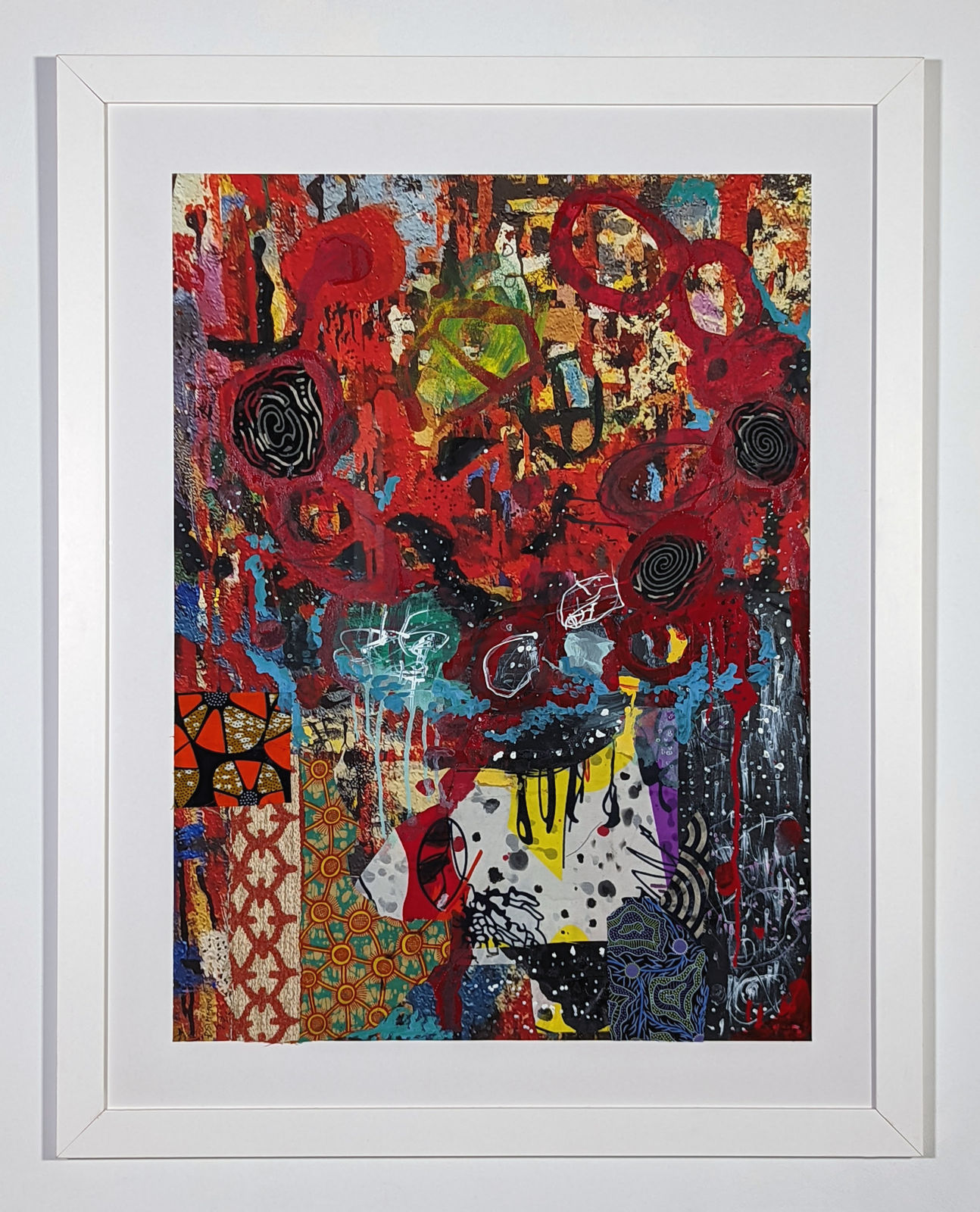 White framed colorful artwork comprised of oil and patterned fabric on print in a 