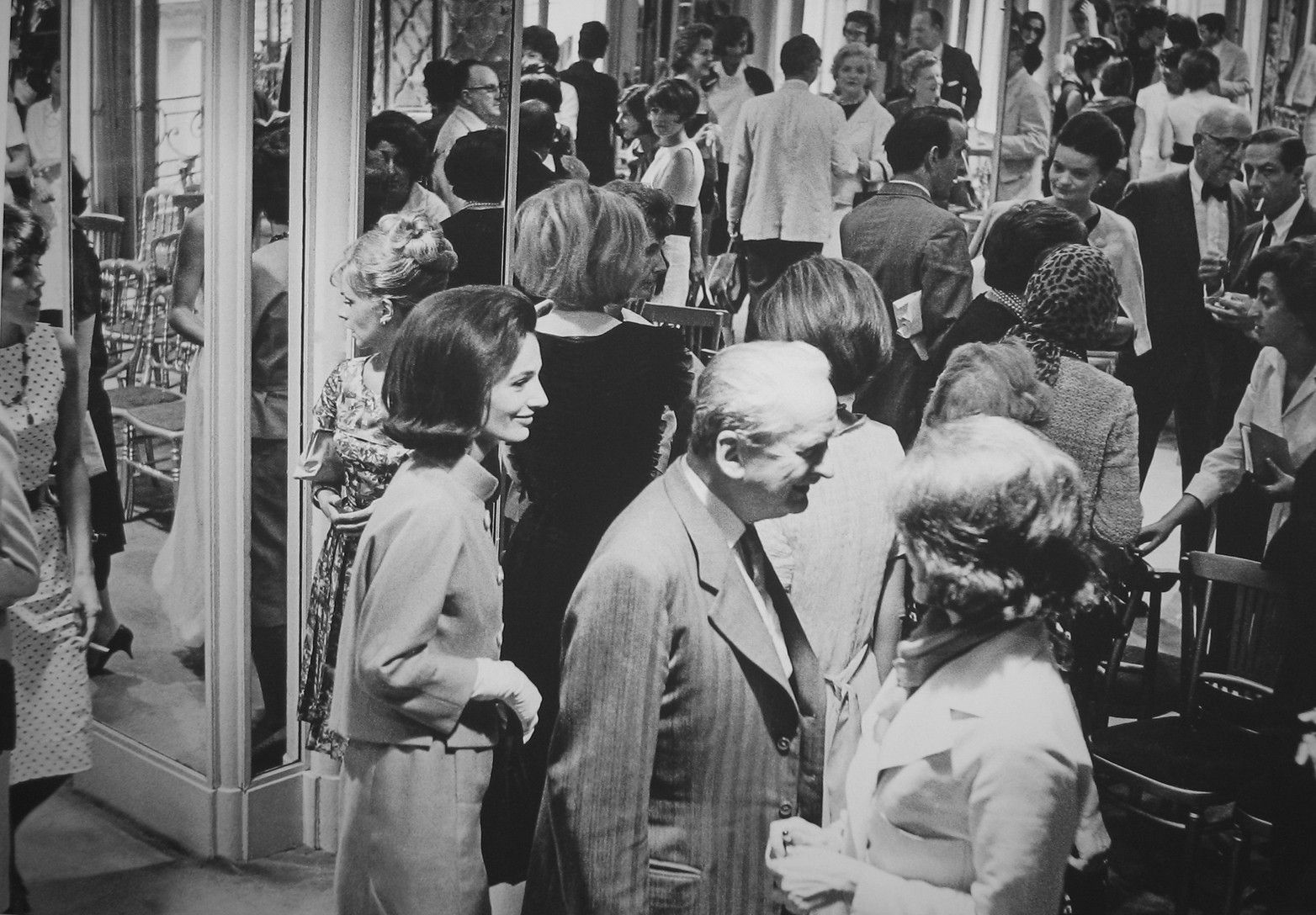 Black and white photograph of a crowd including Lee Radziwill, younger sister of late former first lady Jacqueline Bouvier Kennedy Onassis, at the House of Chanel