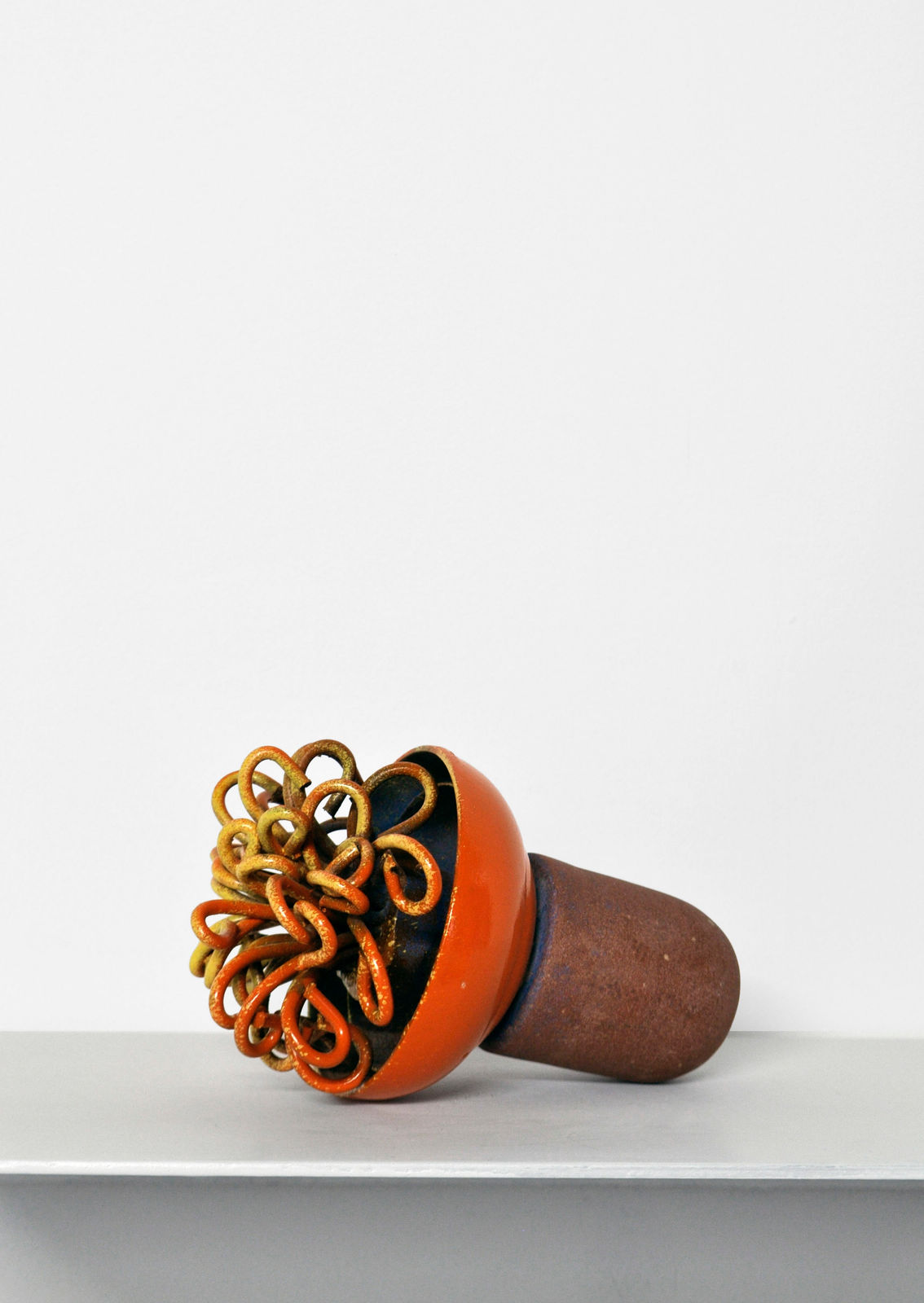 Contemporary minimalist sculpture made of stone and metal that resembles an ambiguous artifact