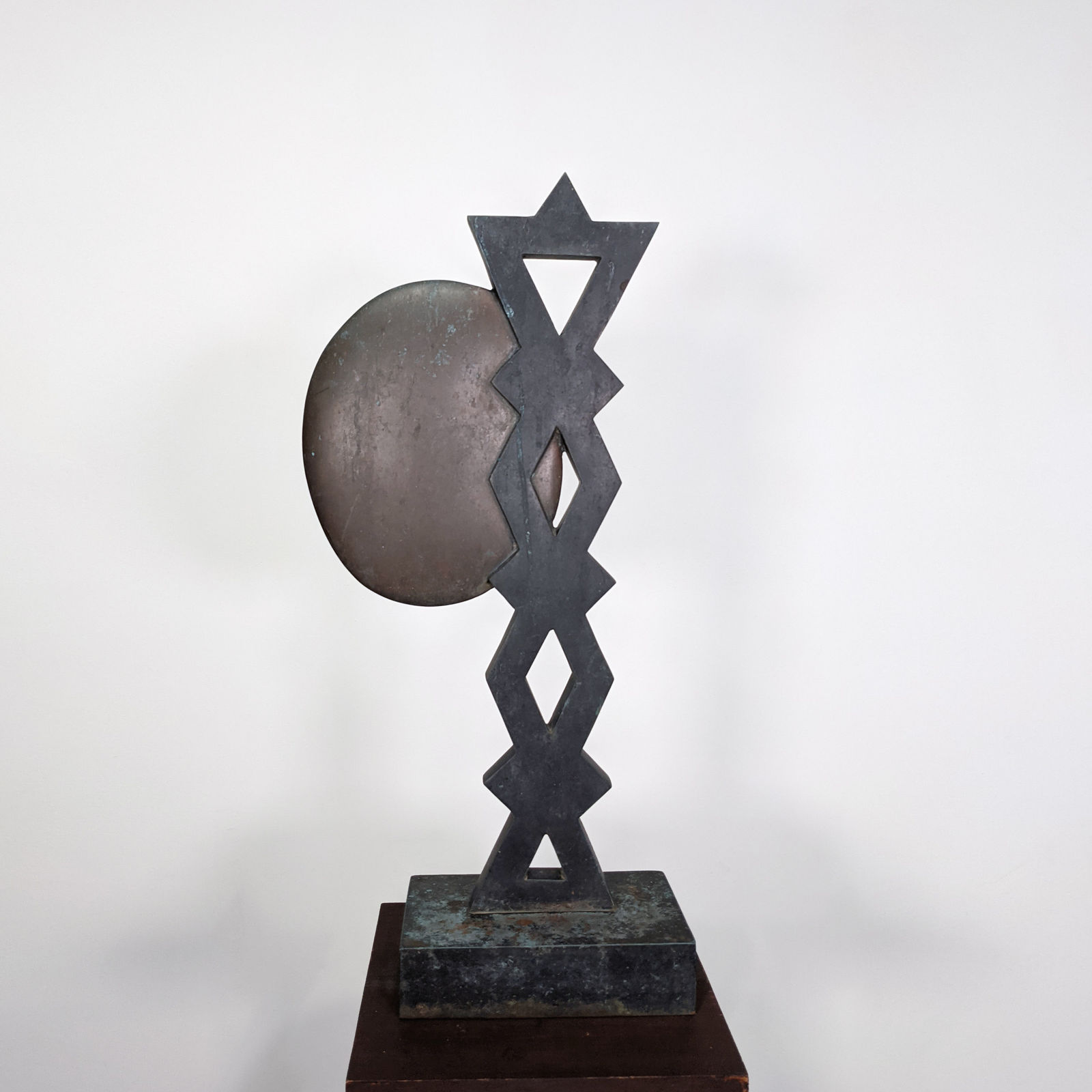 Detail of Modernist bronze sculpture of a stylized profile with a braided hairdo reminiscent of folklore motifs, on bronze base