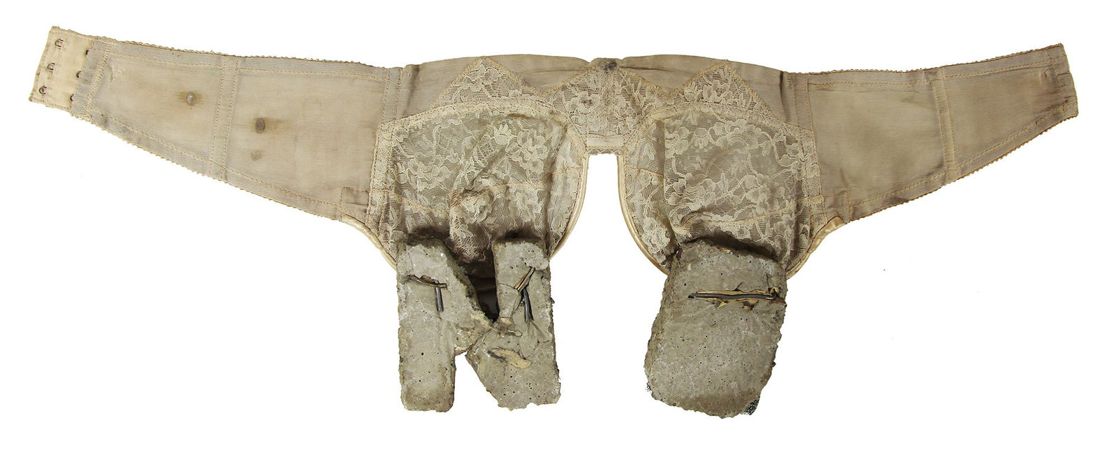 White lace bra with cement blocks in the shape of letters N & O hanging from the cups