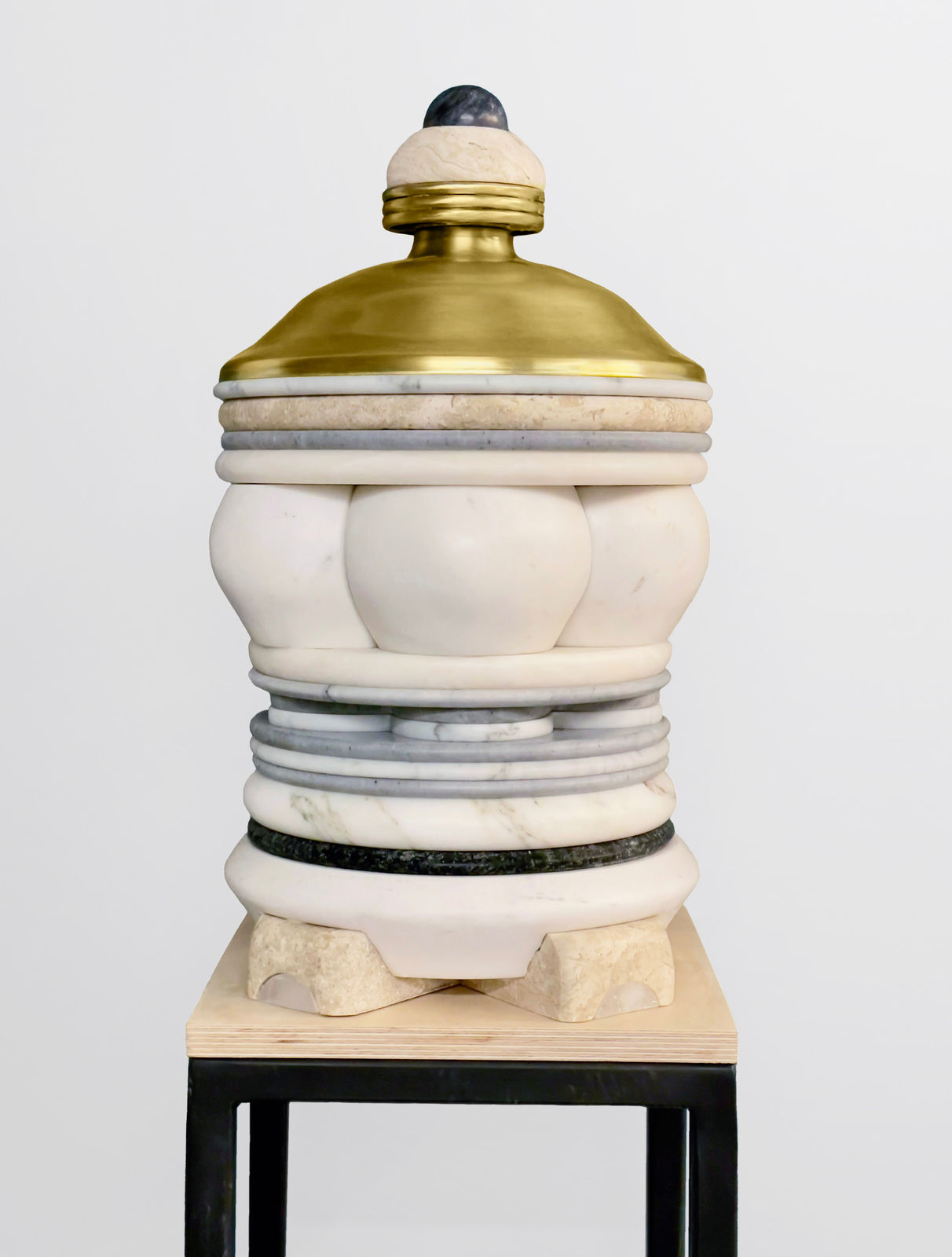 Medium-sized sculpture comprising layers of marble, brass, and stone of varying color and thickness