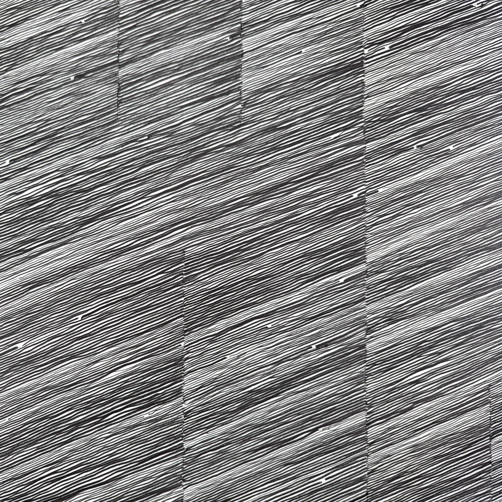 Detail of Graphite on paper, gray and black lines moving across the page, in a wave motion.