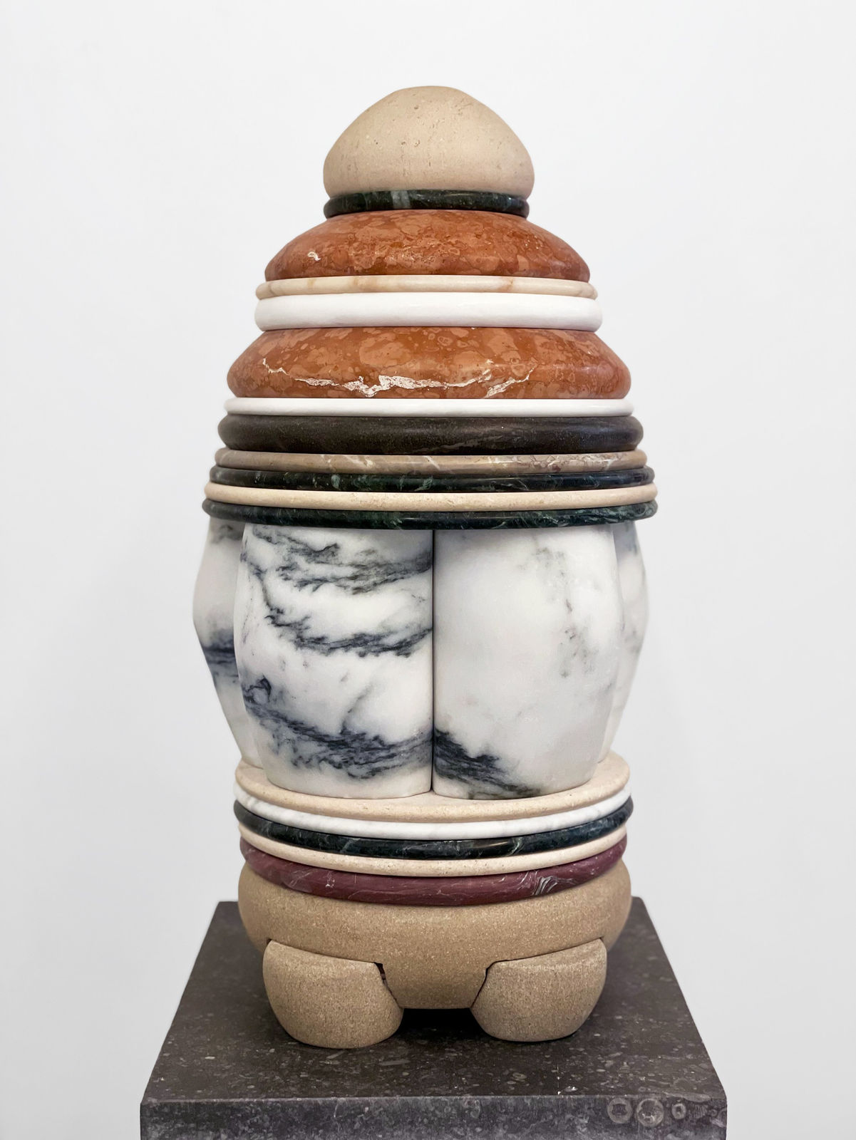 Medium-sized sculpture comprising layers of foliated marble and stone of varying color and thickness