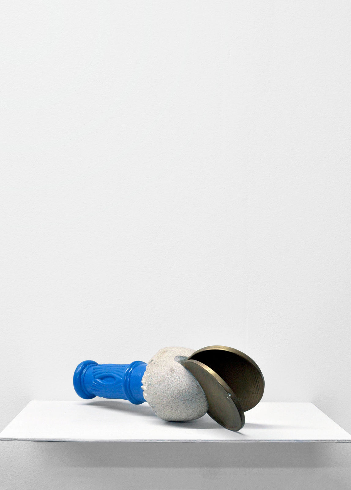 Contemporary minimalist sculpture made of stone and metal that resembles an ambiguous artifact