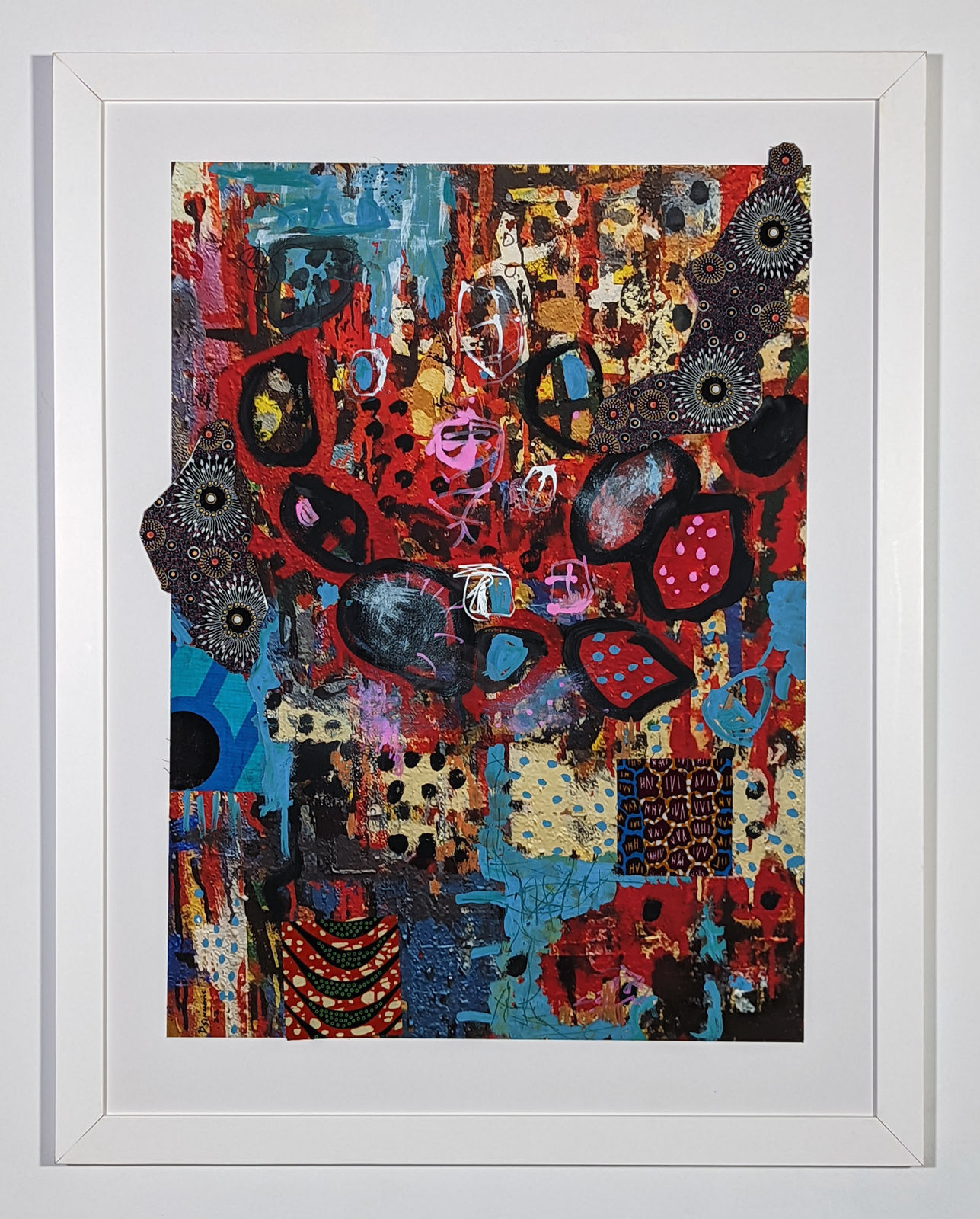 White framed colorful artwork comprised of oil and patterned fabric on print in a 