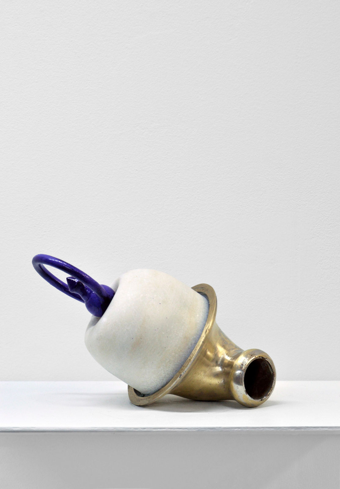 Contemporary minimalist sculpture made of stone and metal that resembles an ambiguous artifact