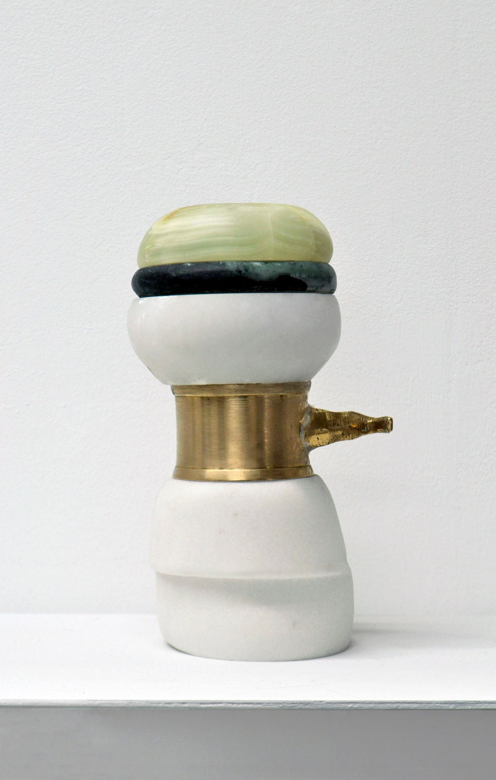 Contemporary minimalist sculpture made of stone and metal that resembles an ambiguous artifact