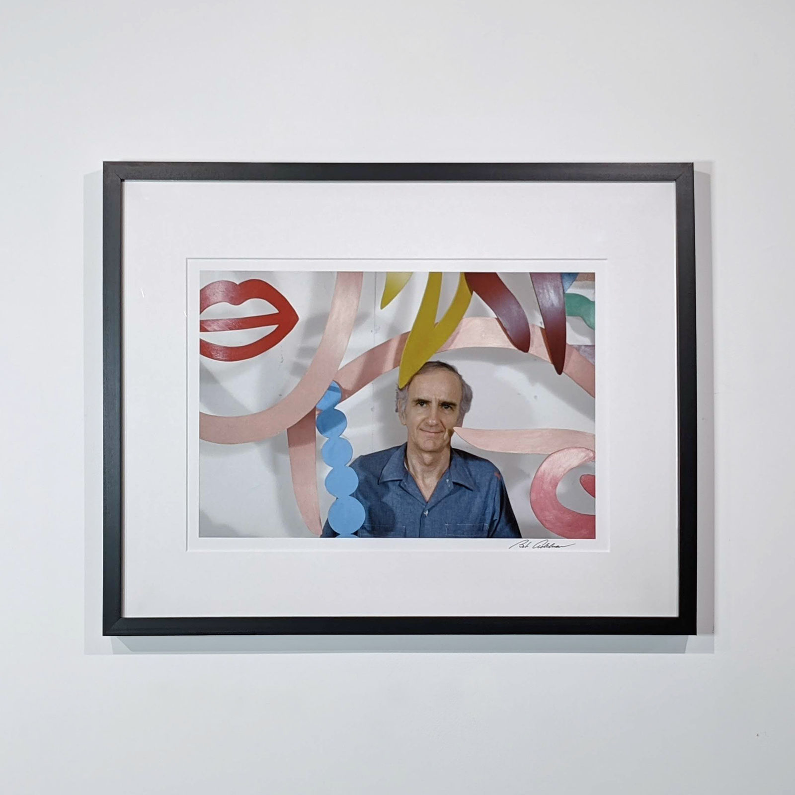Framed Photograph of Tom Wesselmann behind a laser-cut steel sculpture of a woman