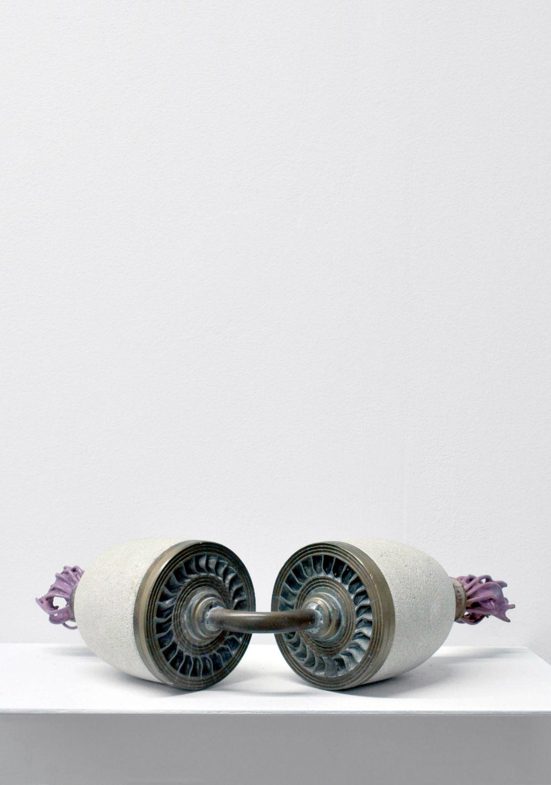 Contemporary minimalist sculpture made of stone and metal that resembles an ambiguous artifact