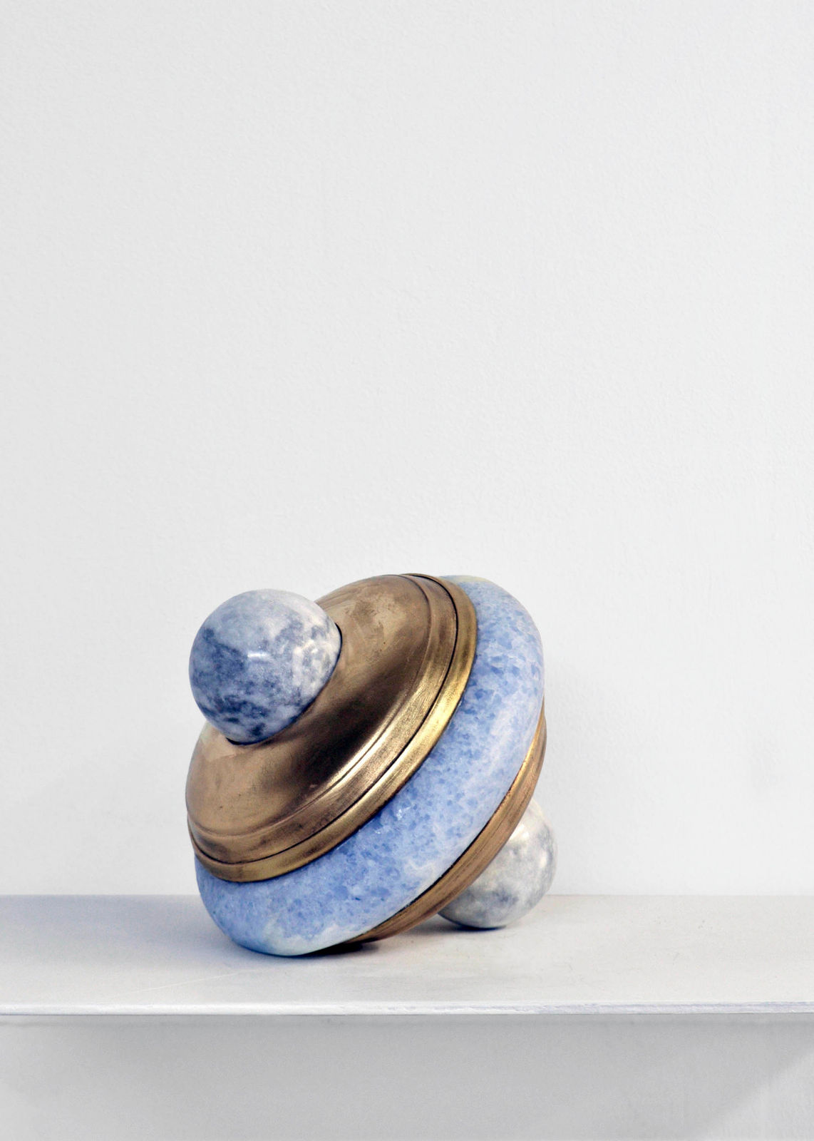 Contemporary minimalist sculpture made of stone and metal that resembles an ambiguous artifact