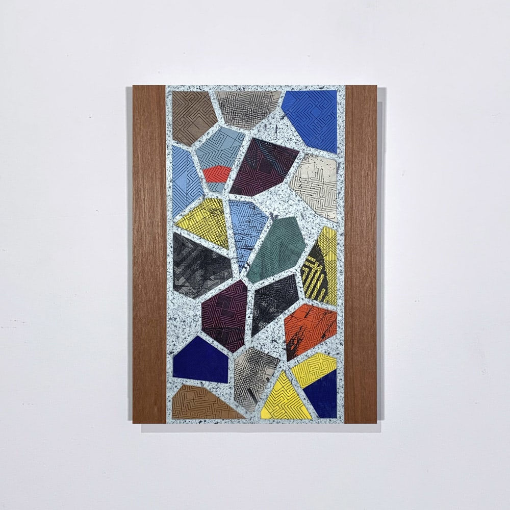 Mixed media work on paper with backed linen of two wood panels encasing a black a light gray splattered rectangle with prisms in brown, gray, blue, black, and white containing interwoven lines.